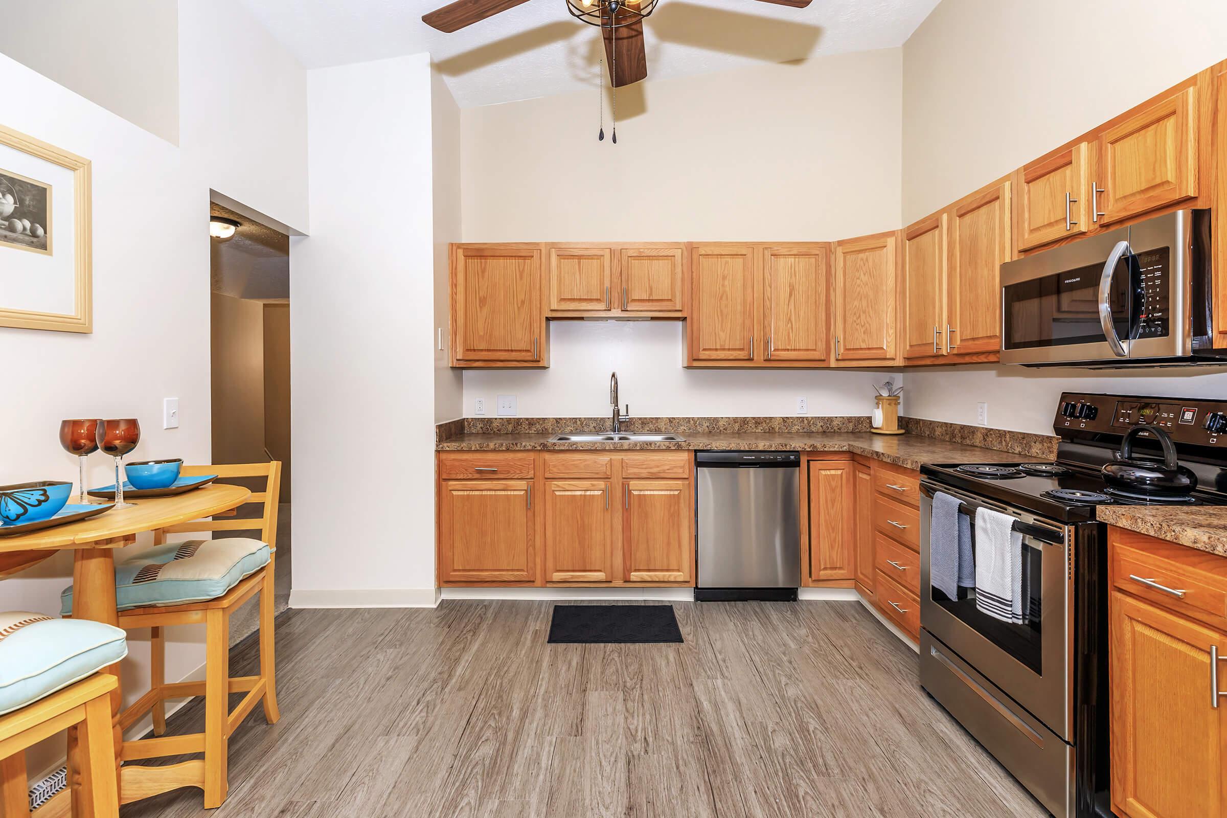 a kitchen with stainless steel appliances and wooden cabinets