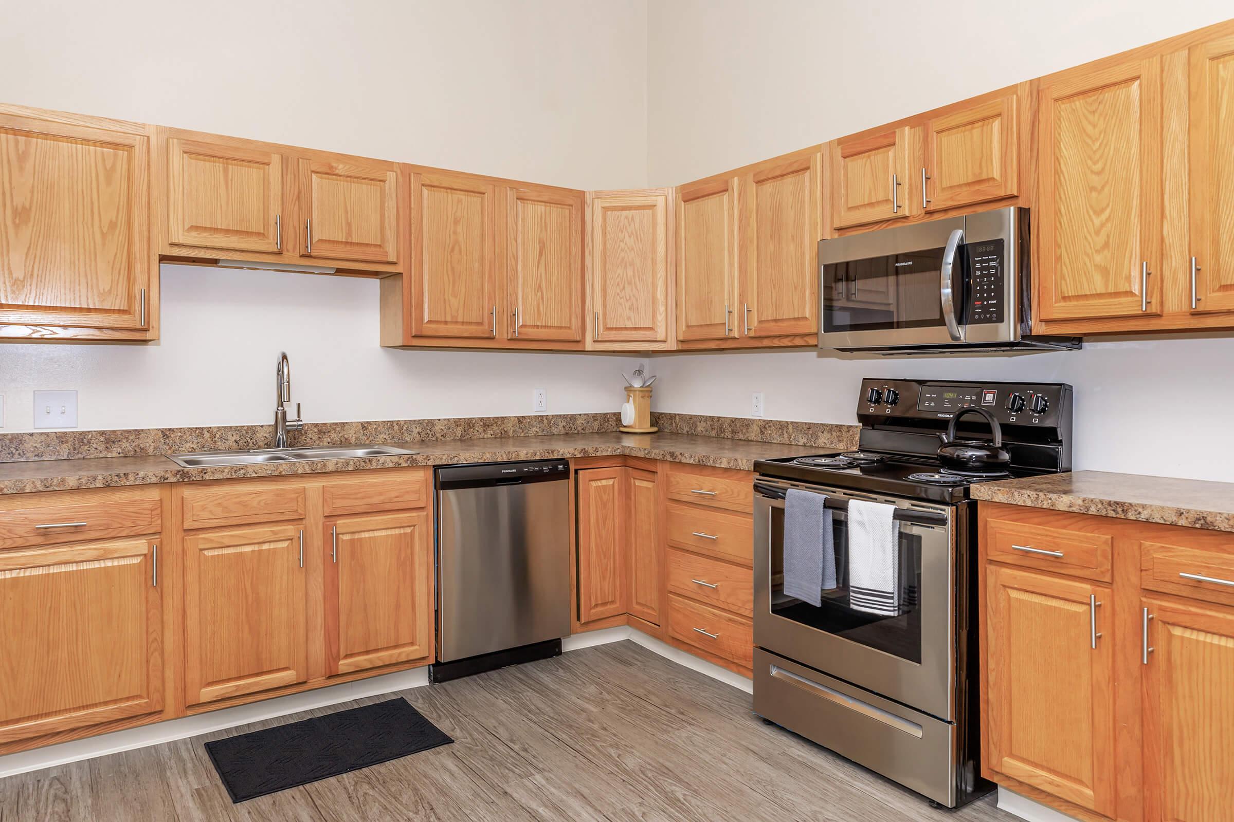 a kitchen with stainless steel appliances and wooden cabinets