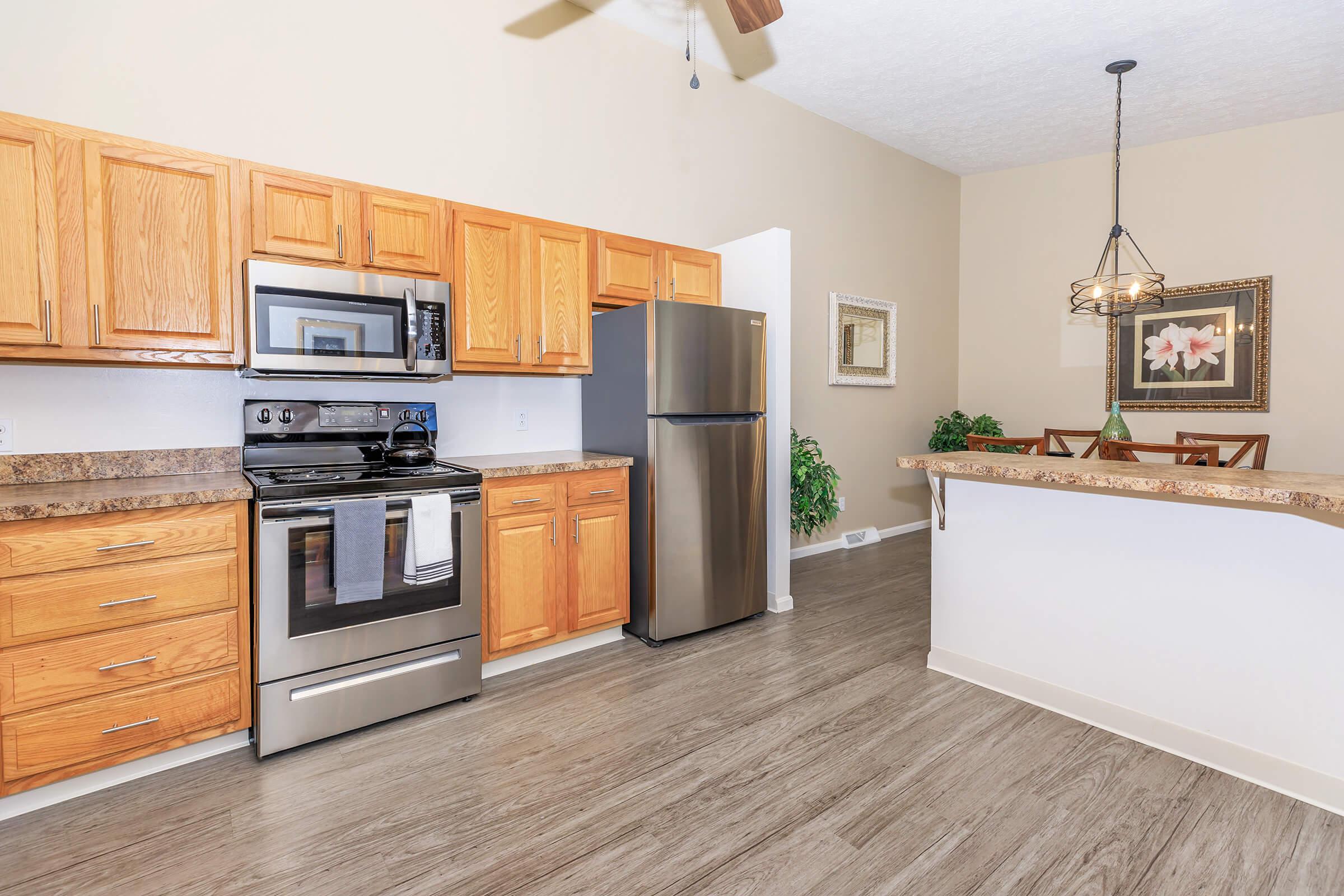 a kitchen with a stove and a refrigerator