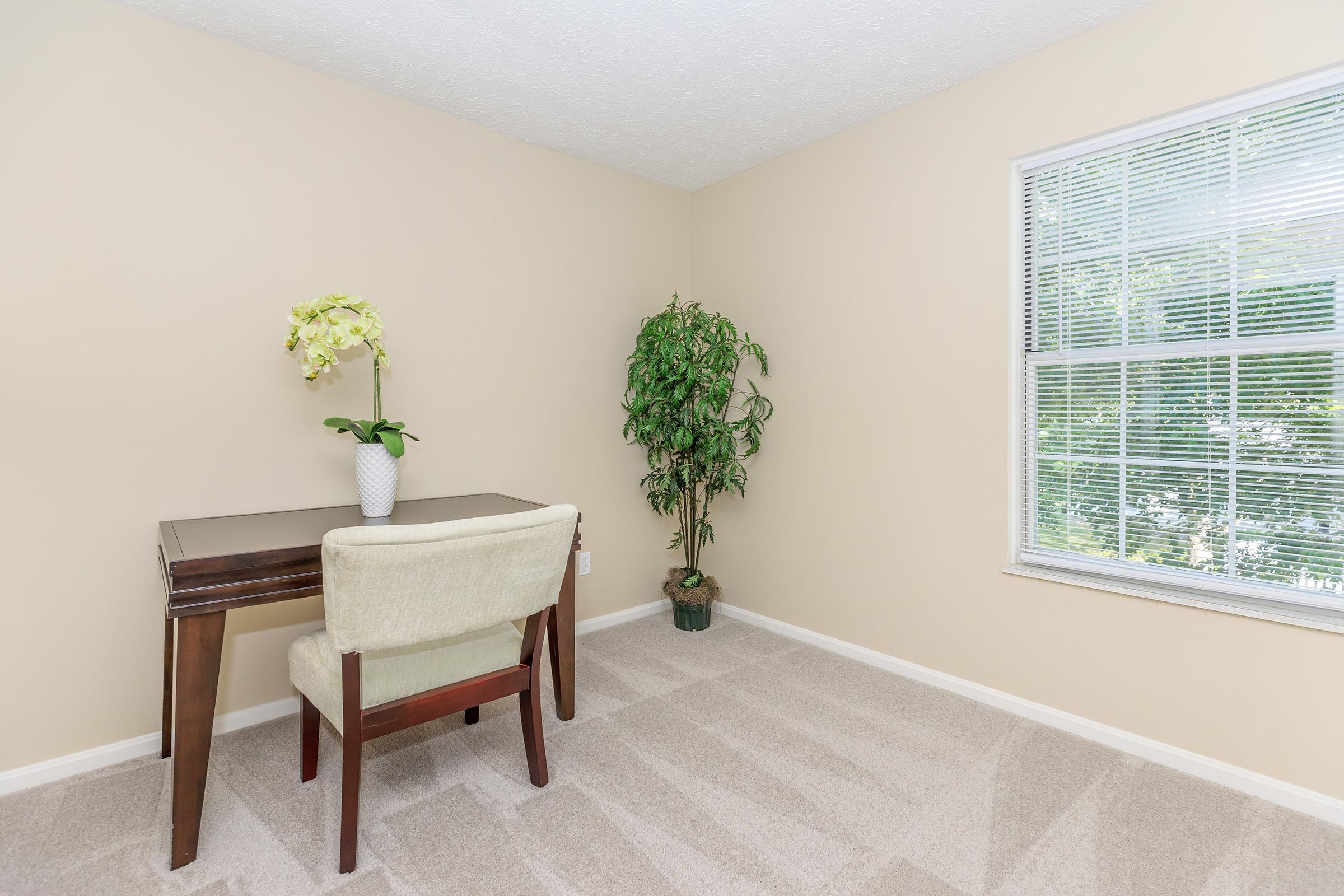 a living room filled with furniture and a large window