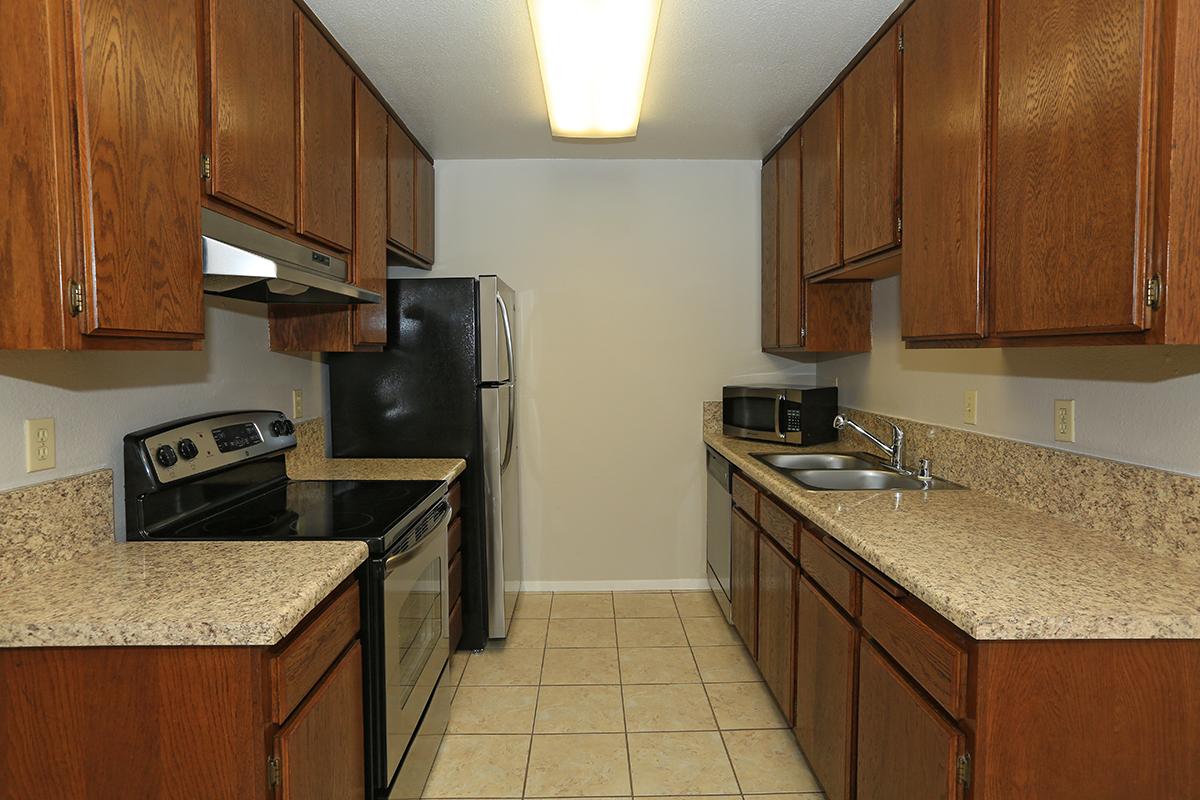 a kitchen with stainless steel appliances and wooden cabinets