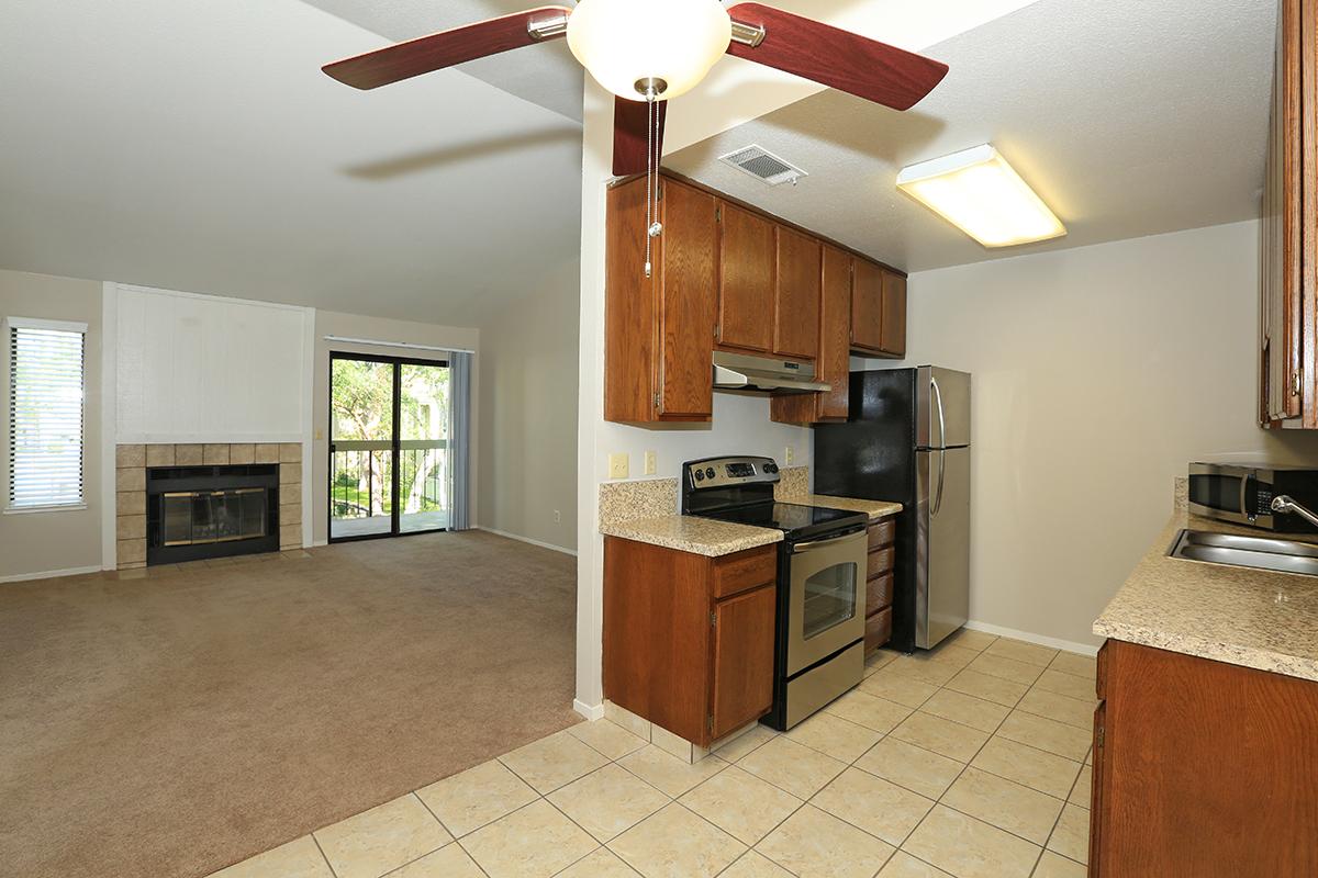 a large kitchen with stainless steel appliances and wooden cabinets