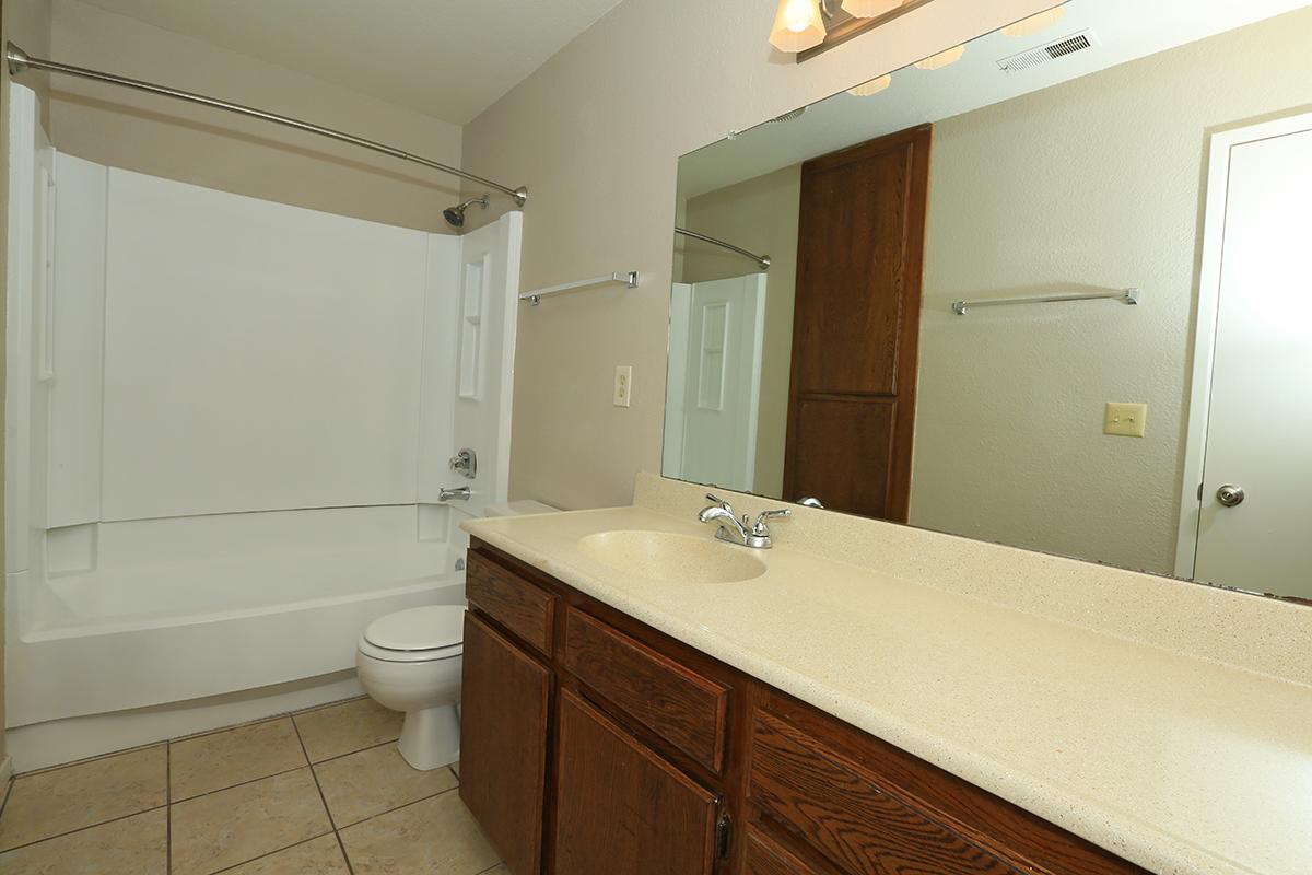 a kitchen with a sink and a mirror