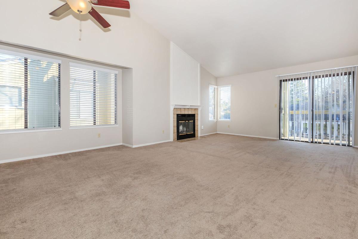 a living room filled with furniture and a large window