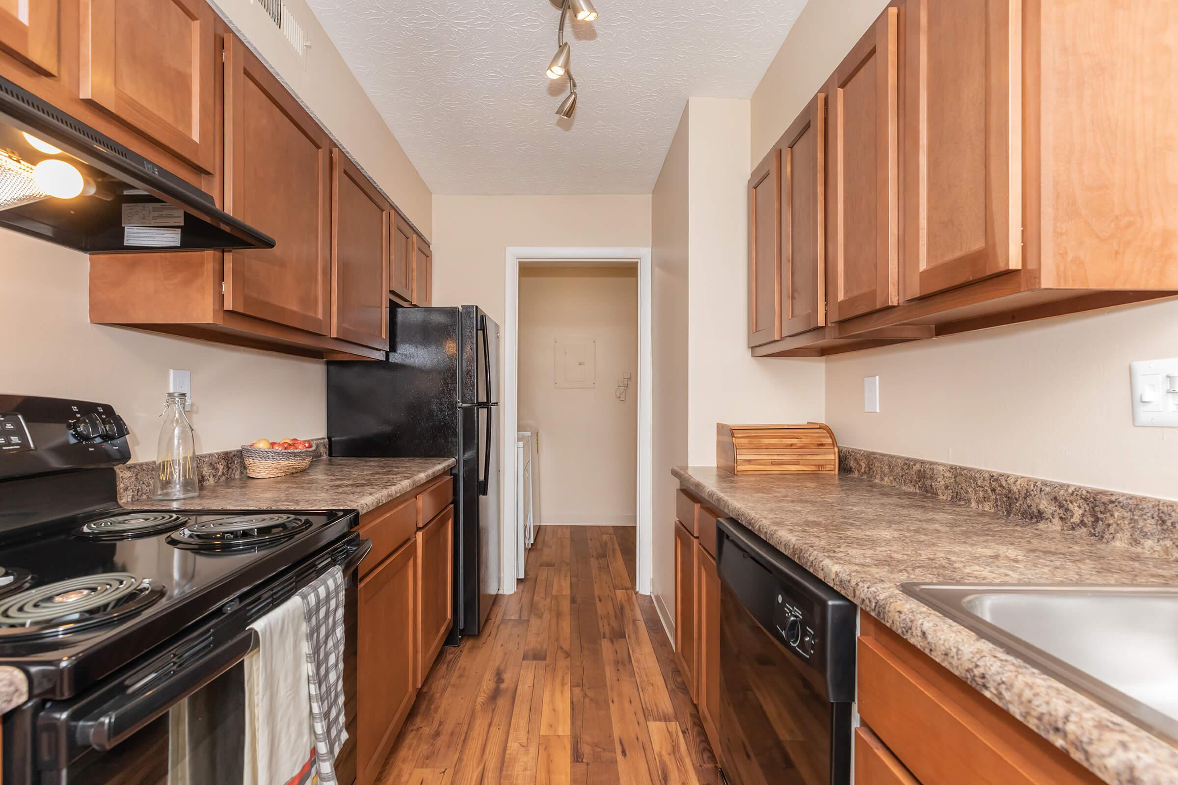 a kitchen with stainless steel appliances and wooden cabinets