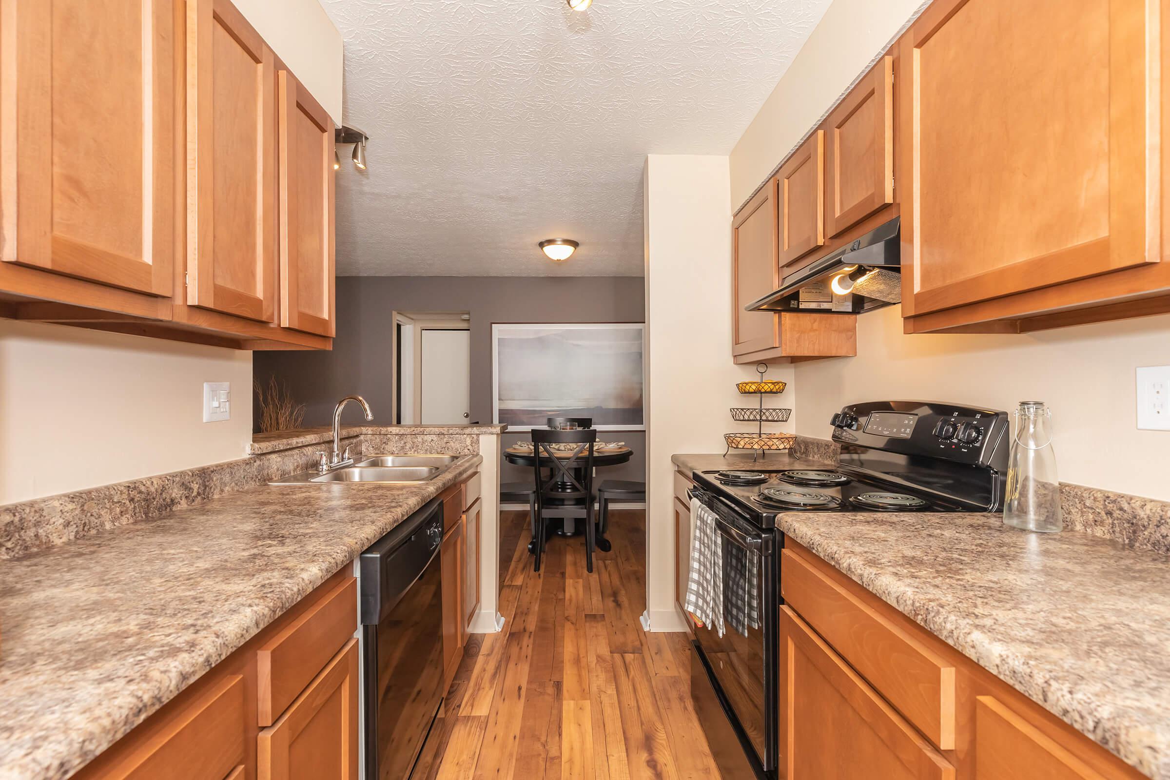 a kitchen with stainless steel appliances and wooden cabinets
