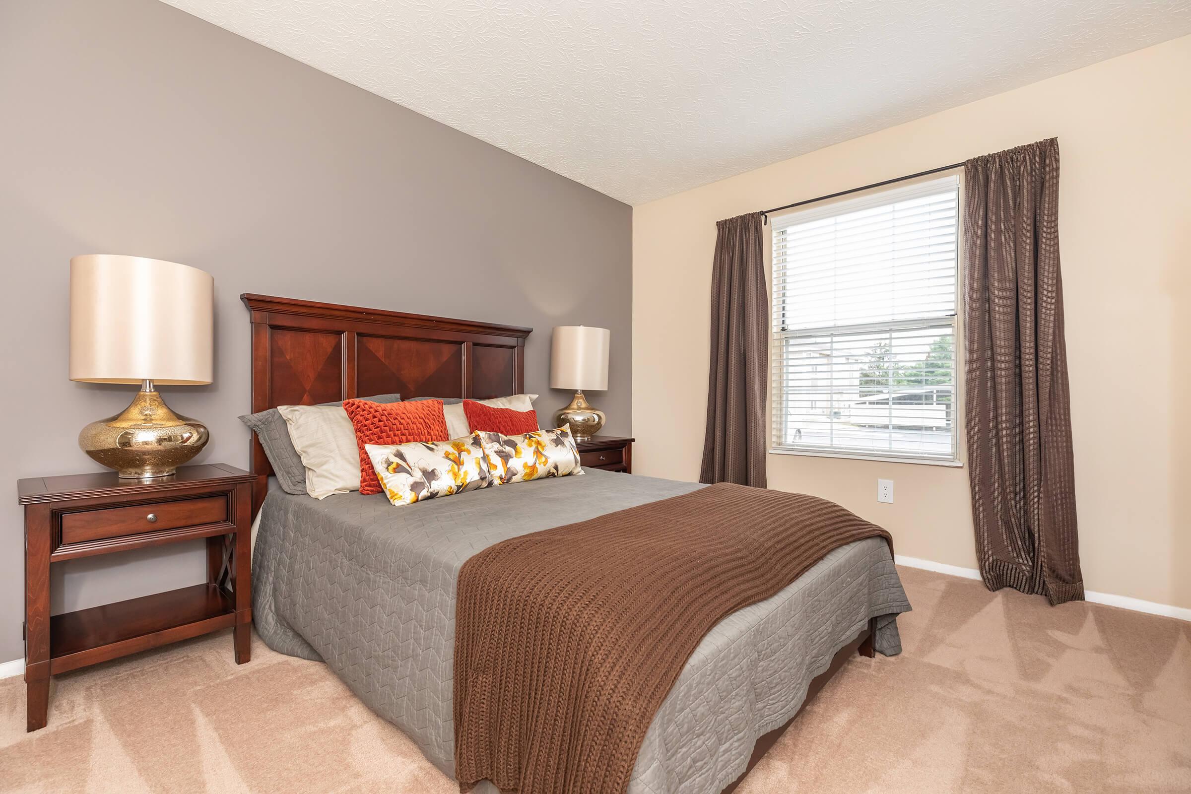 a bedroom with a bed and desk in a room