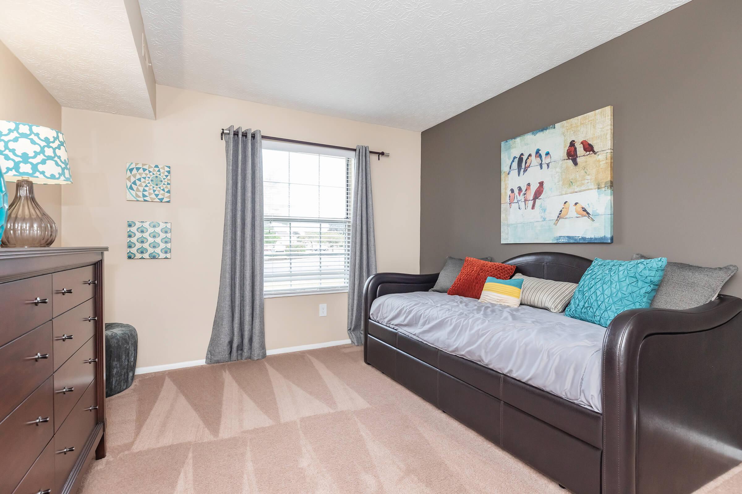 a bedroom with a bed in a room
