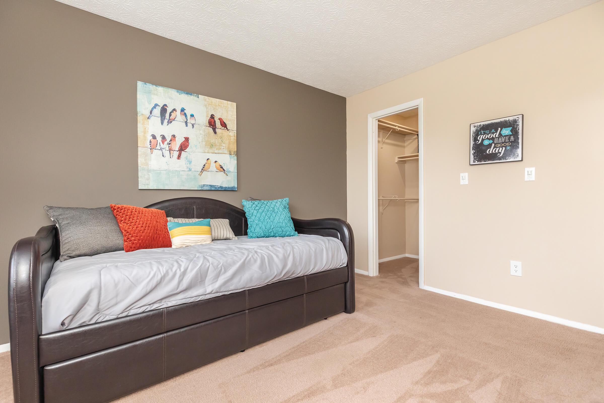 a flat screen tv sitting on top of a bed