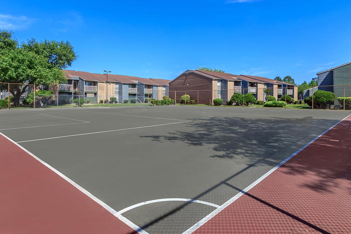 a basketball on a court with a racket