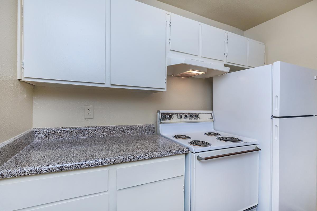 a white stove top oven sitting inside of a kitchen