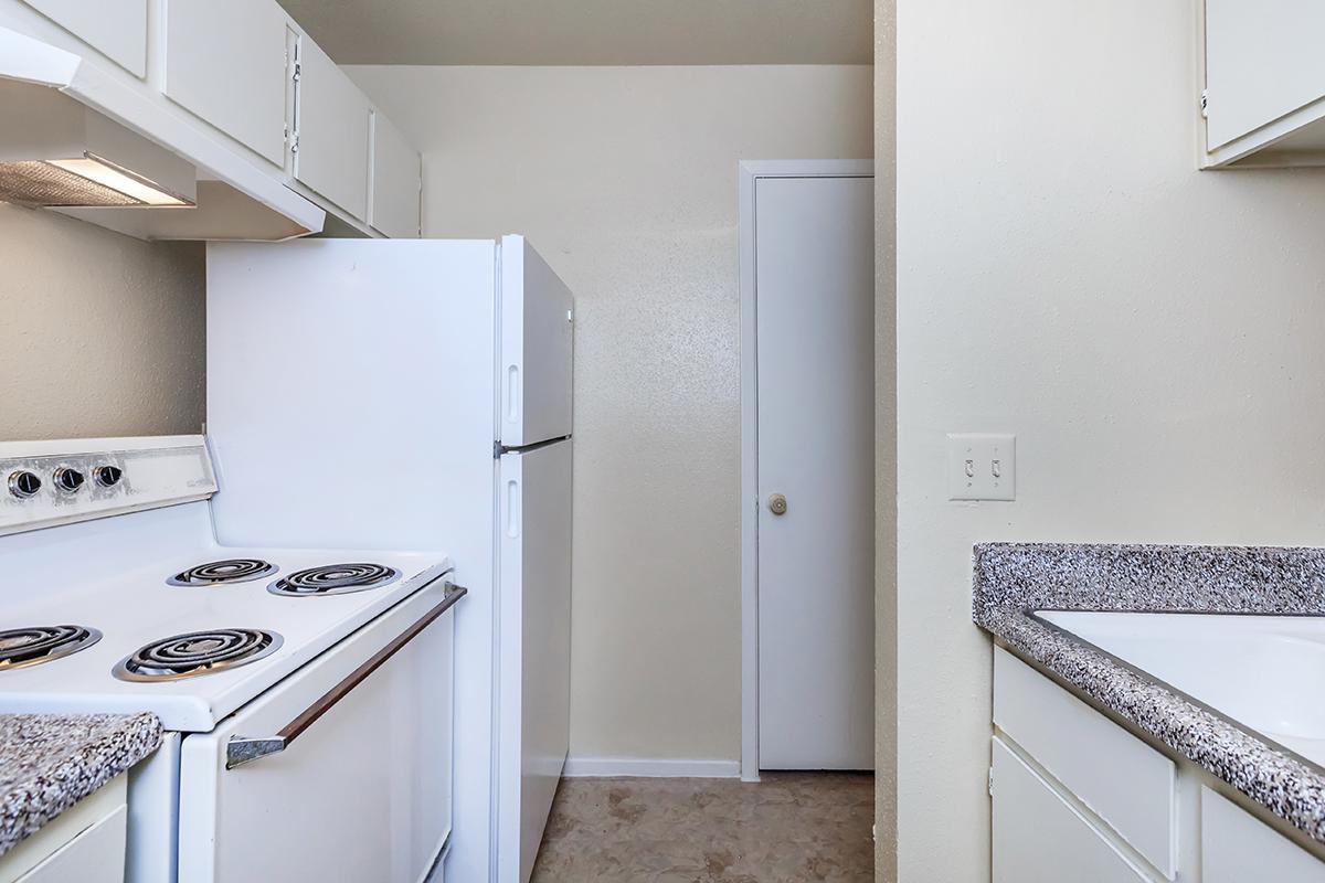 a white stove top oven sitting inside of a kitchen