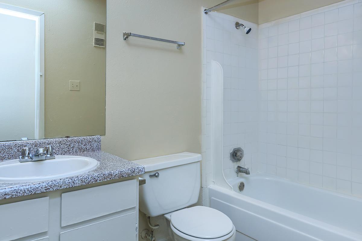 a white tub sitting next to a sink