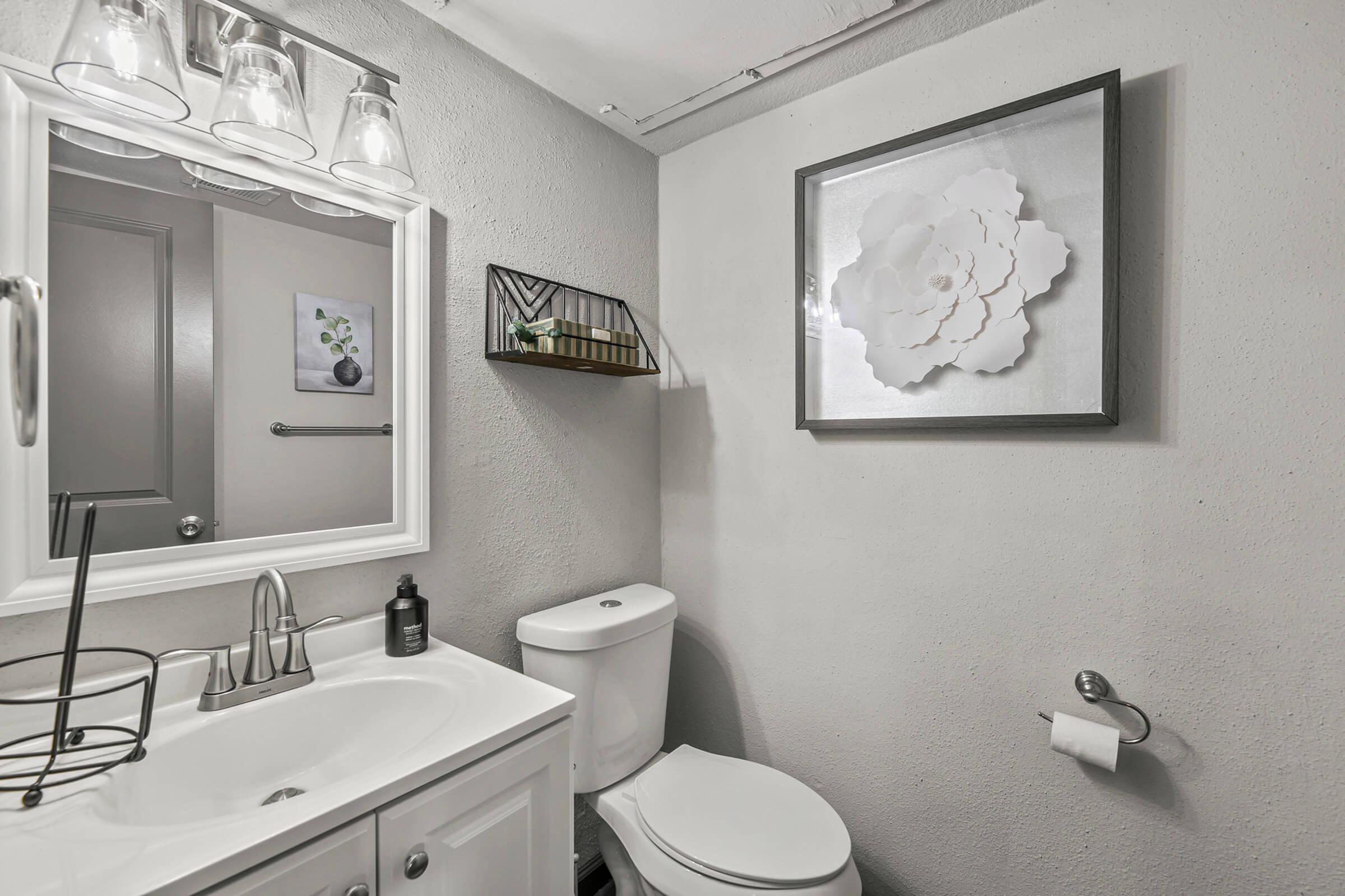 a room with a sink and a mirror