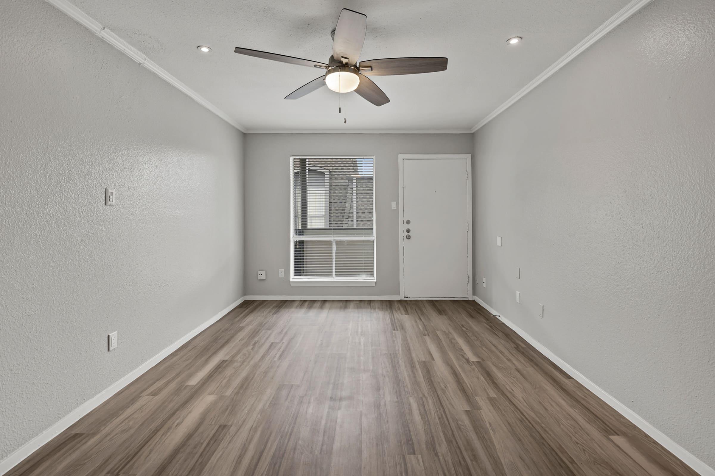 a large empty room with a wooden floor