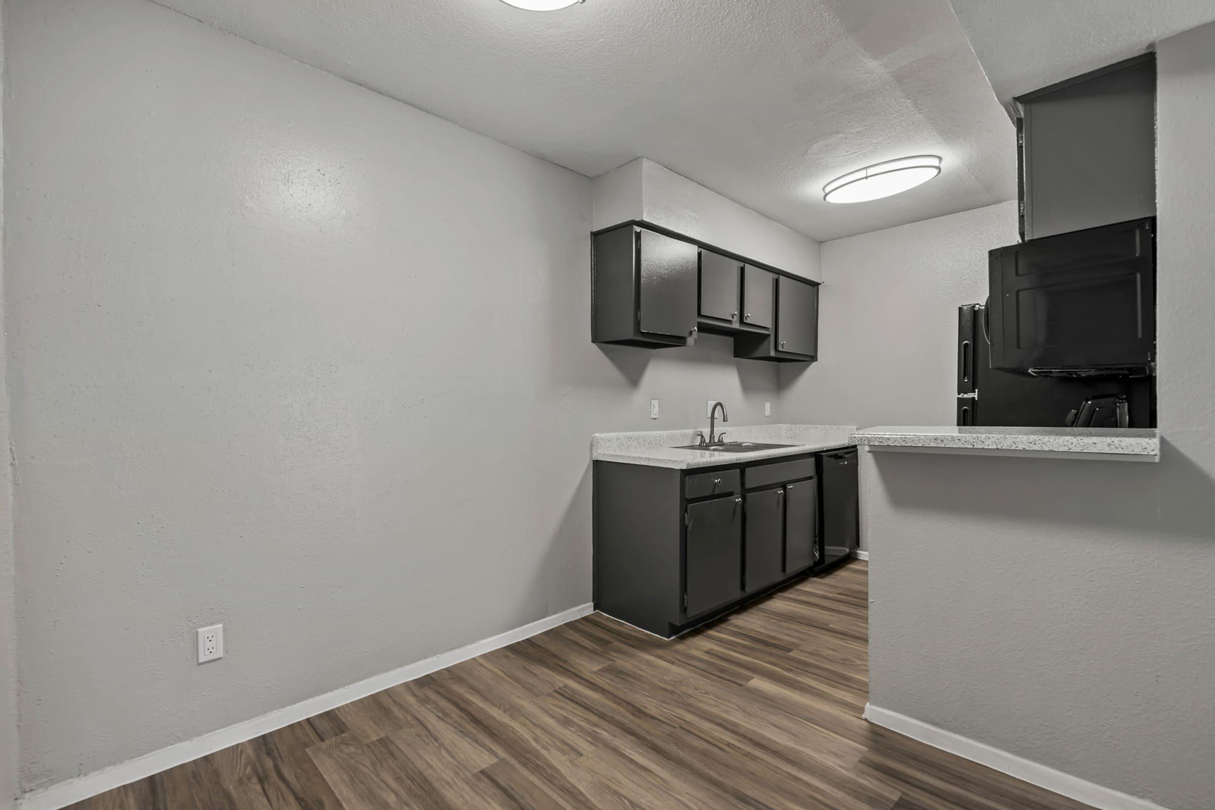 a large empty room with a sink and a mirror
