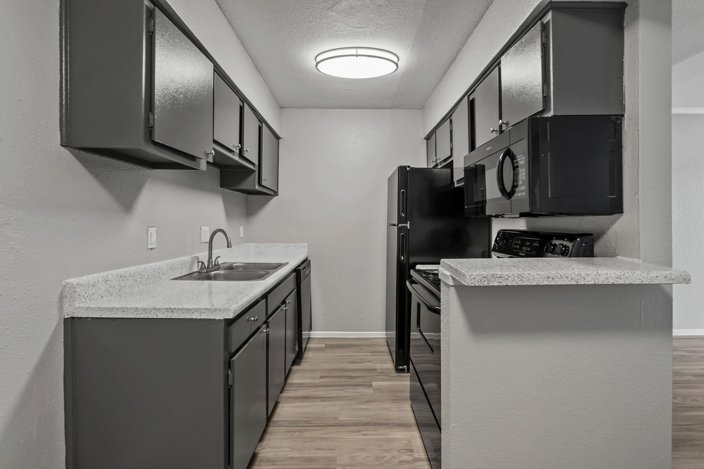 a kitchen with a sink and a mirror