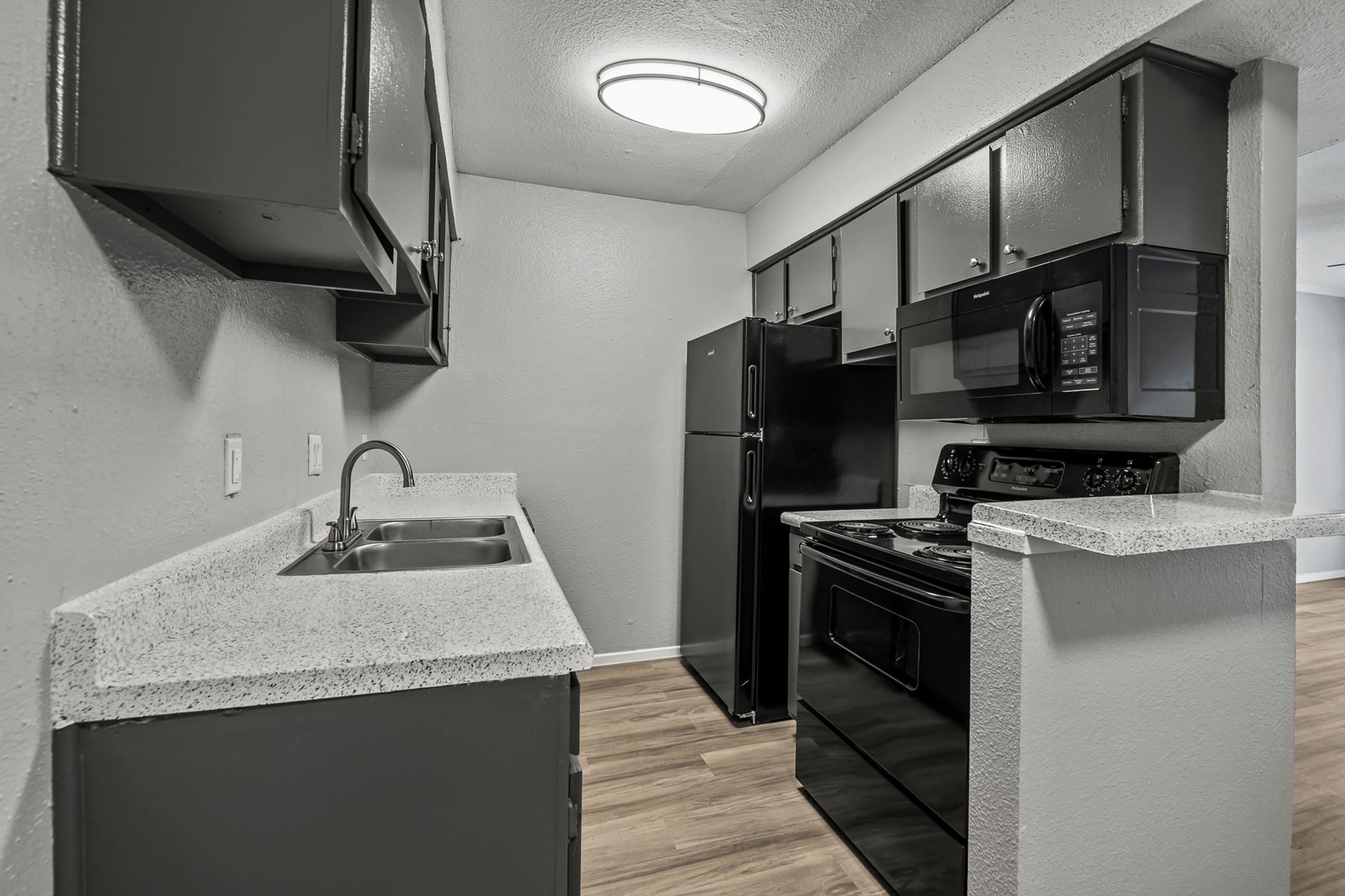 a kitchen with a sink and a mirror