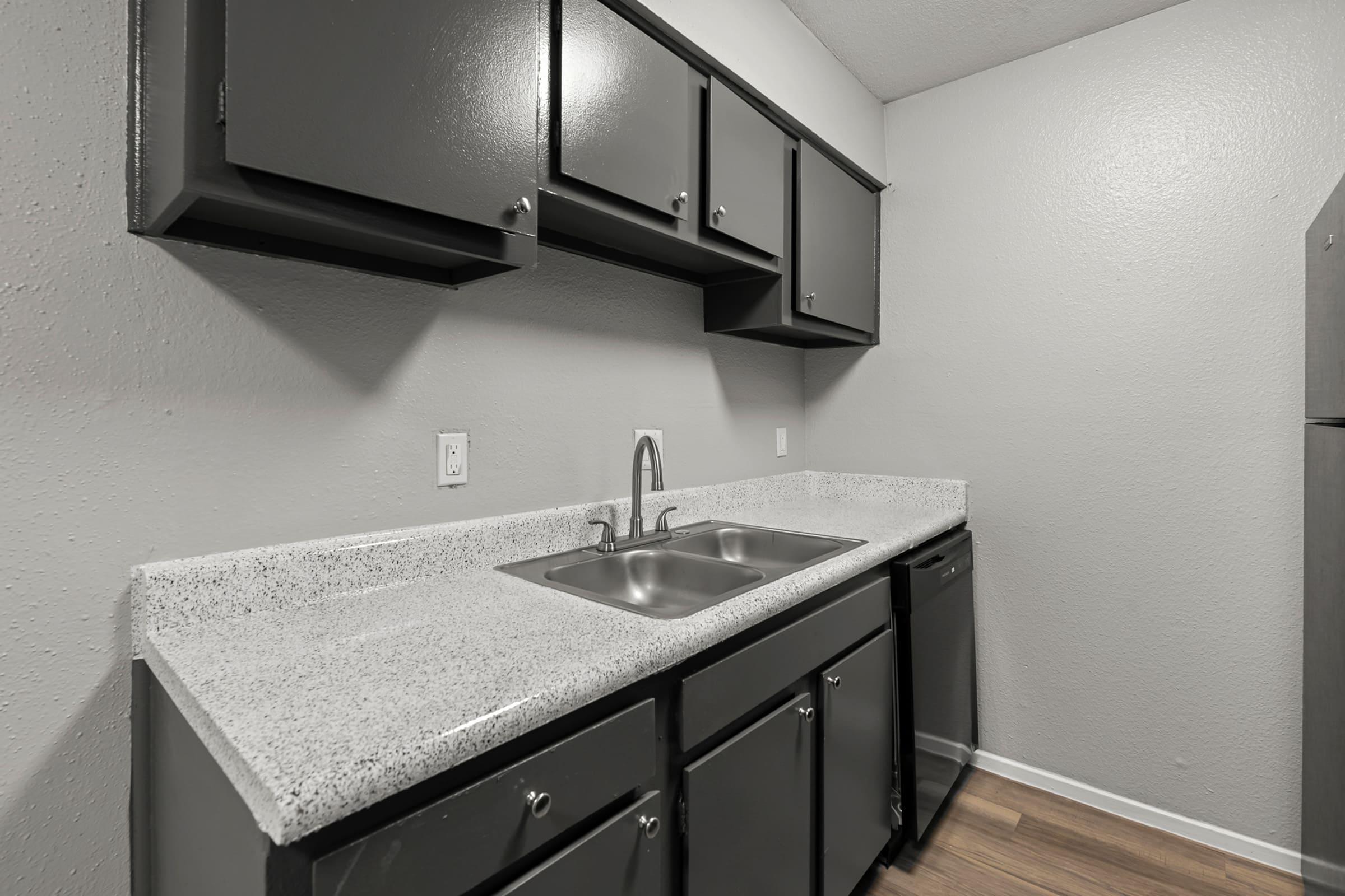 a kitchen with a sink and a mirror
