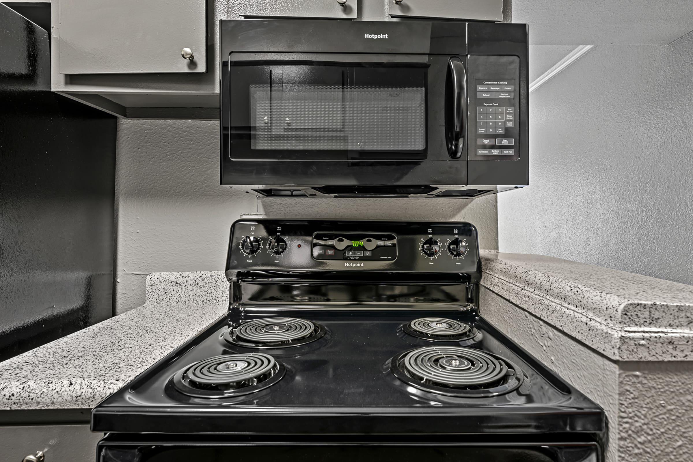 a stove top oven sitting inside of a kitchen