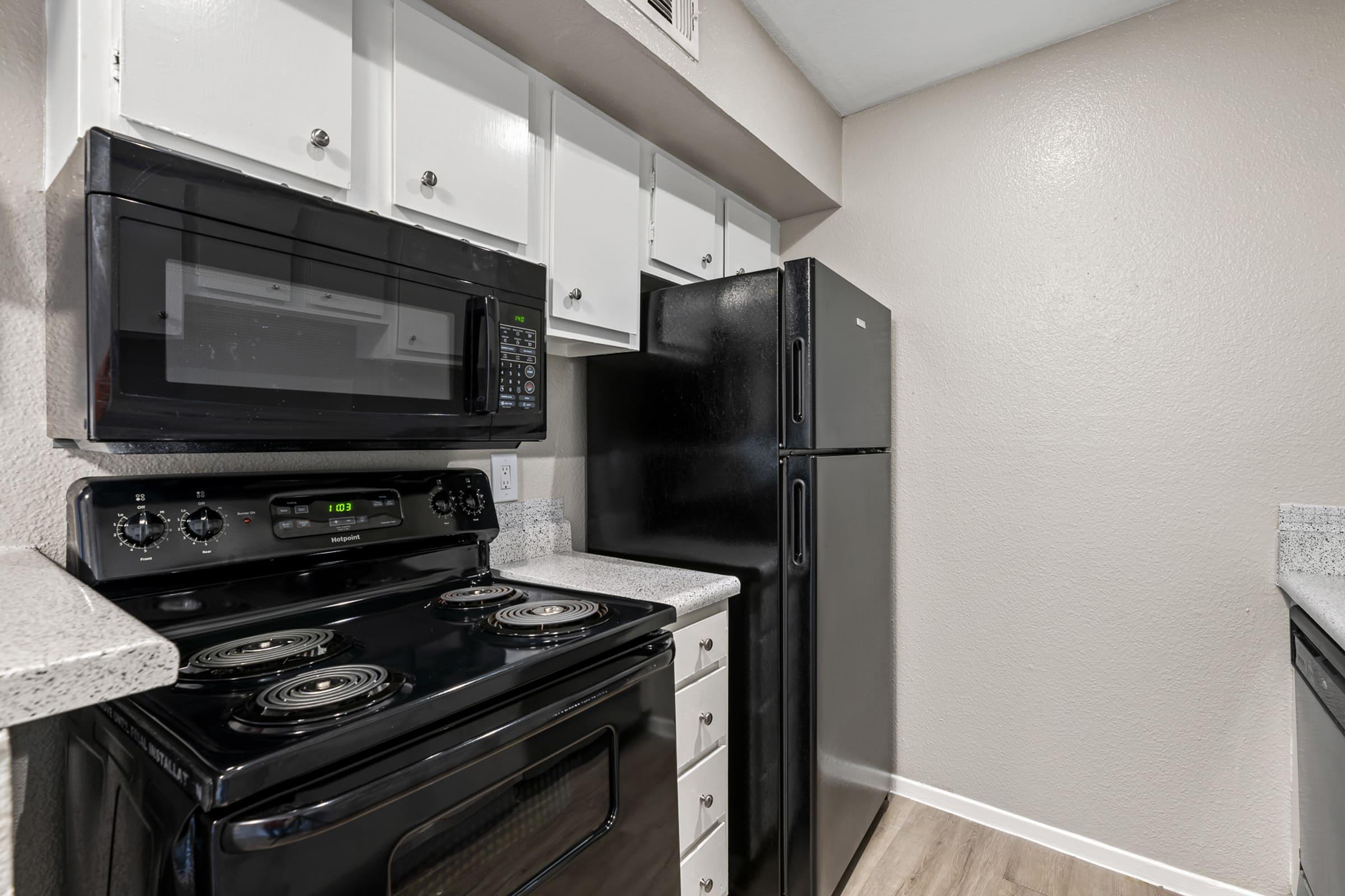 a stove top oven sitting inside of a kitchen