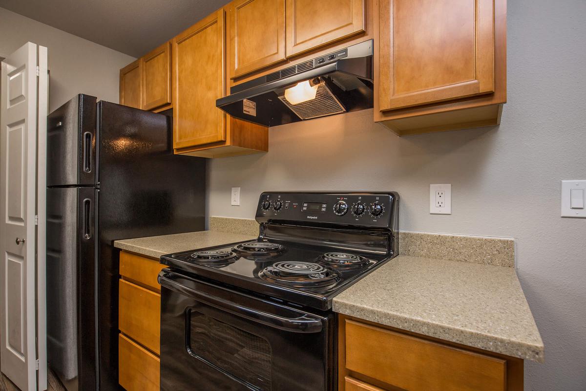 a stove top oven sitting inside of a kitchen