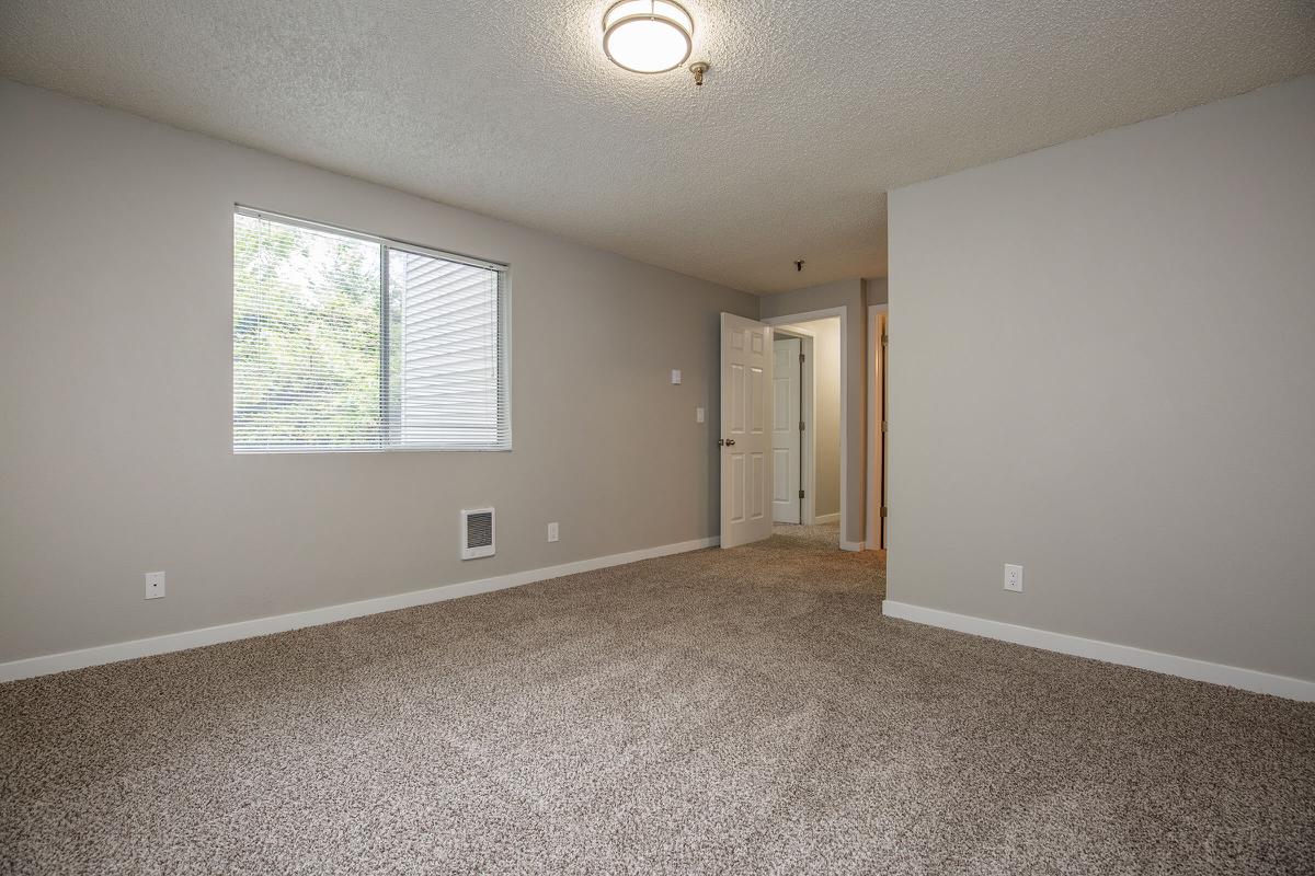 a large empty room with a sink and a mirror