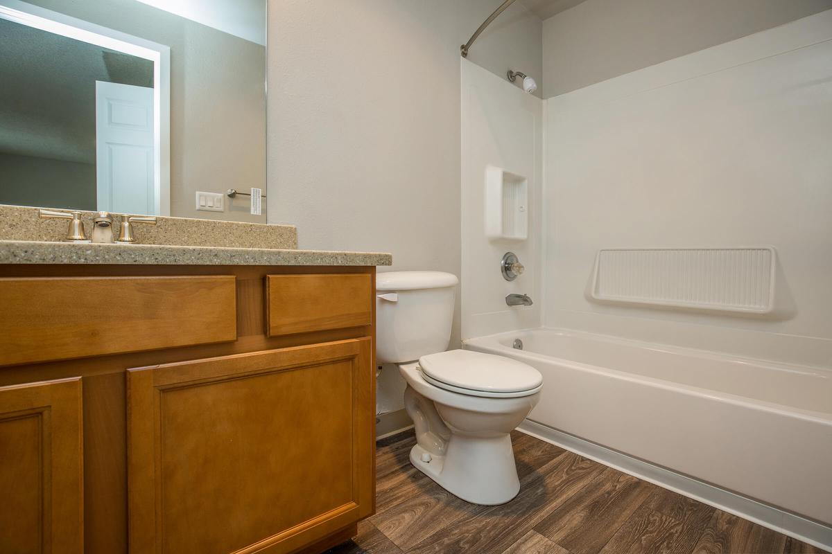 a large white tub sitting next to a sink
