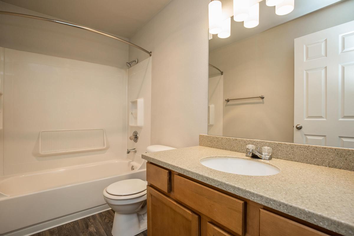 a large white tub sitting next to a sink