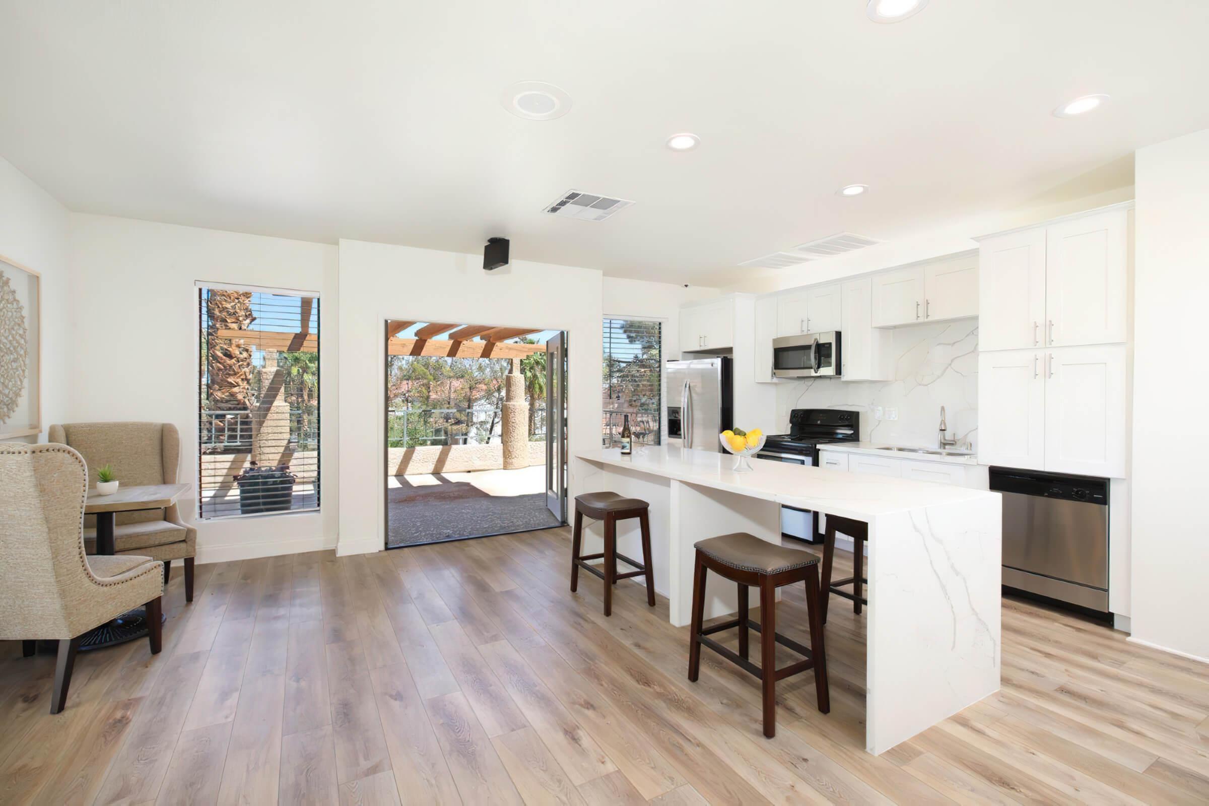 a kitchen with a wood floor in a room