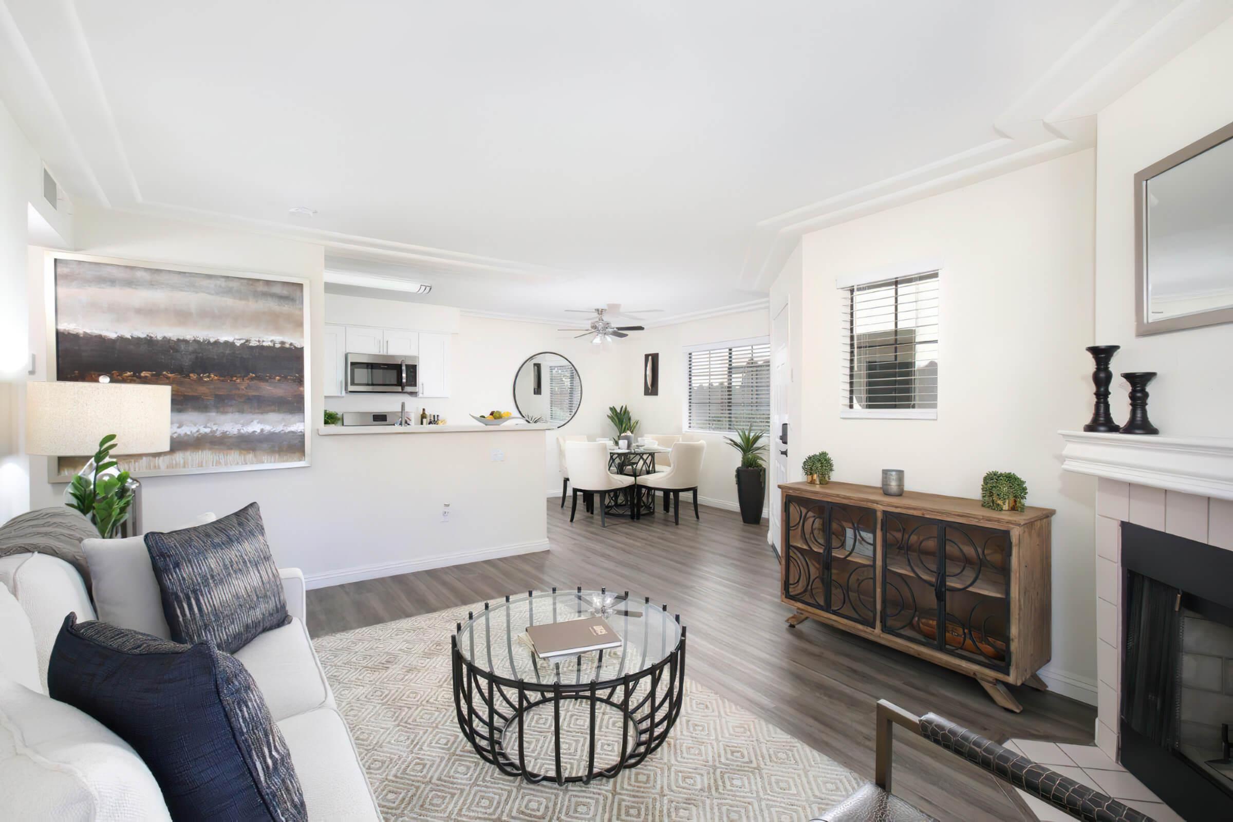 a living room filled with furniture and a large window