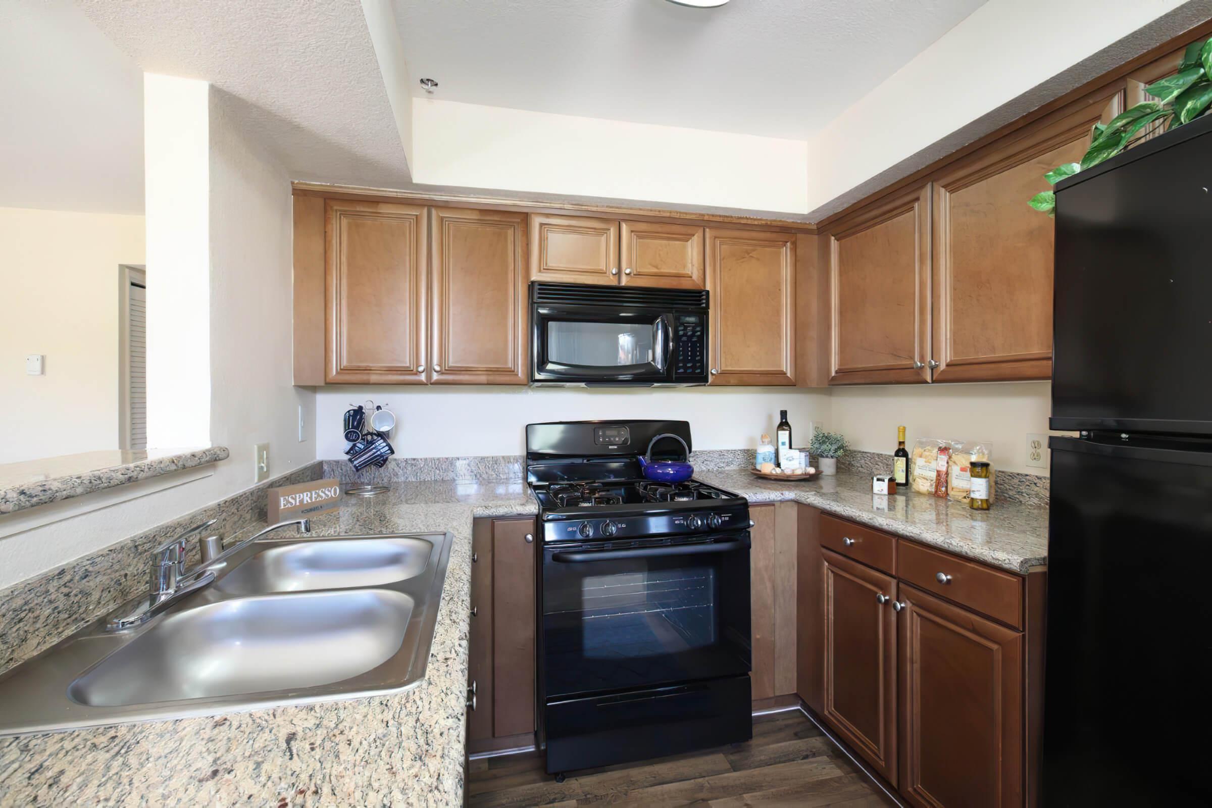 a kitchen with a stove a sink and a microwave