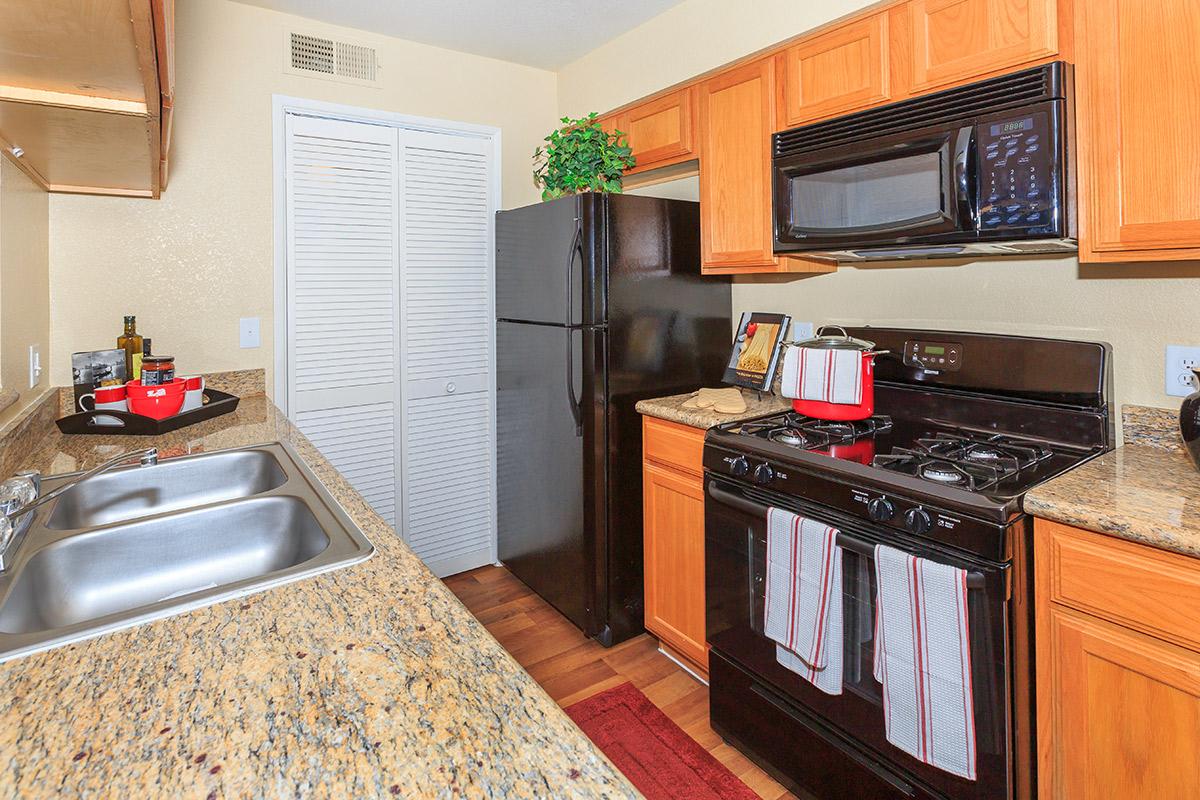 a kitchen with stainless steel appliances and wooden cabinets