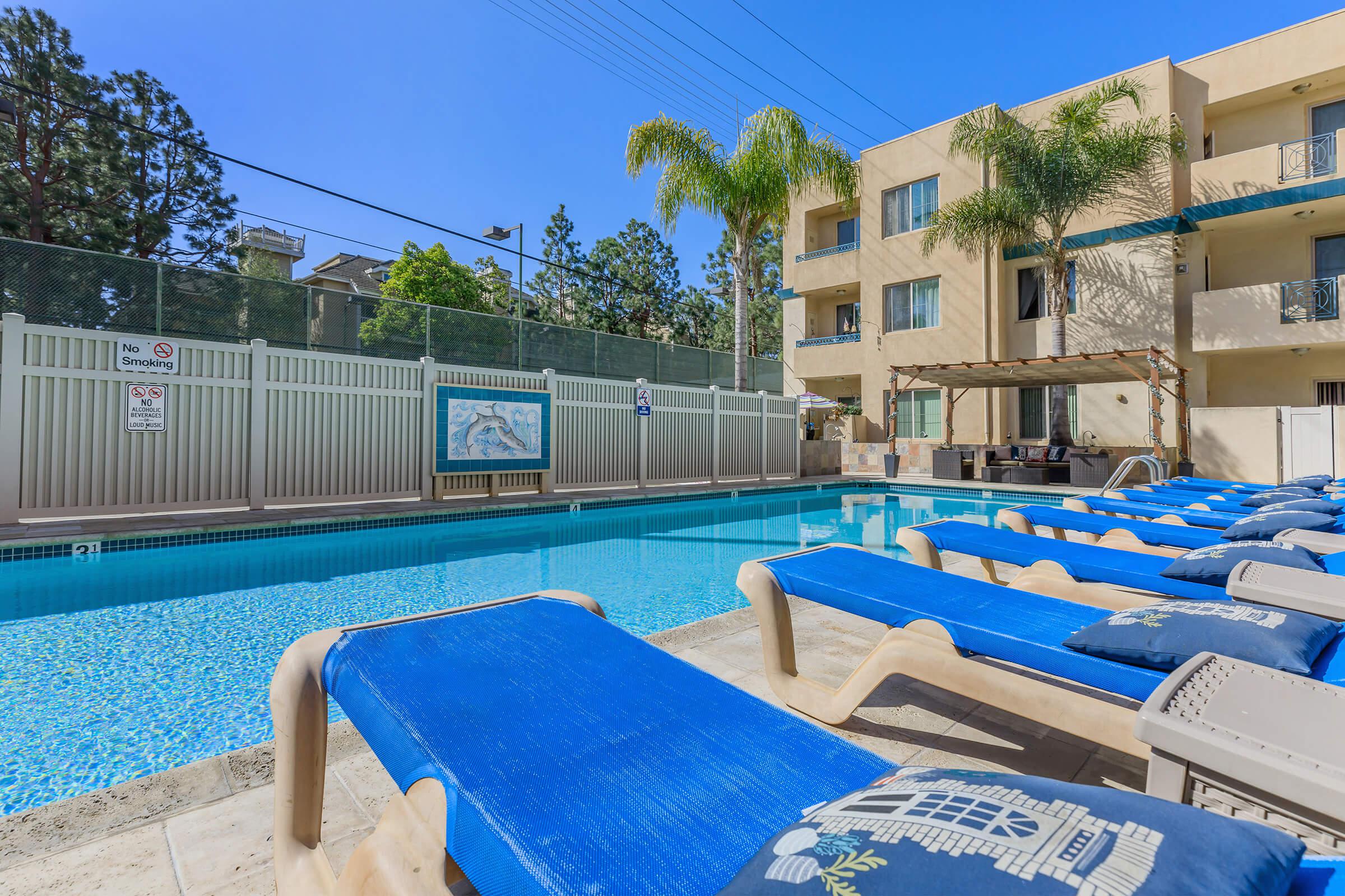 The community pool with blue chairs