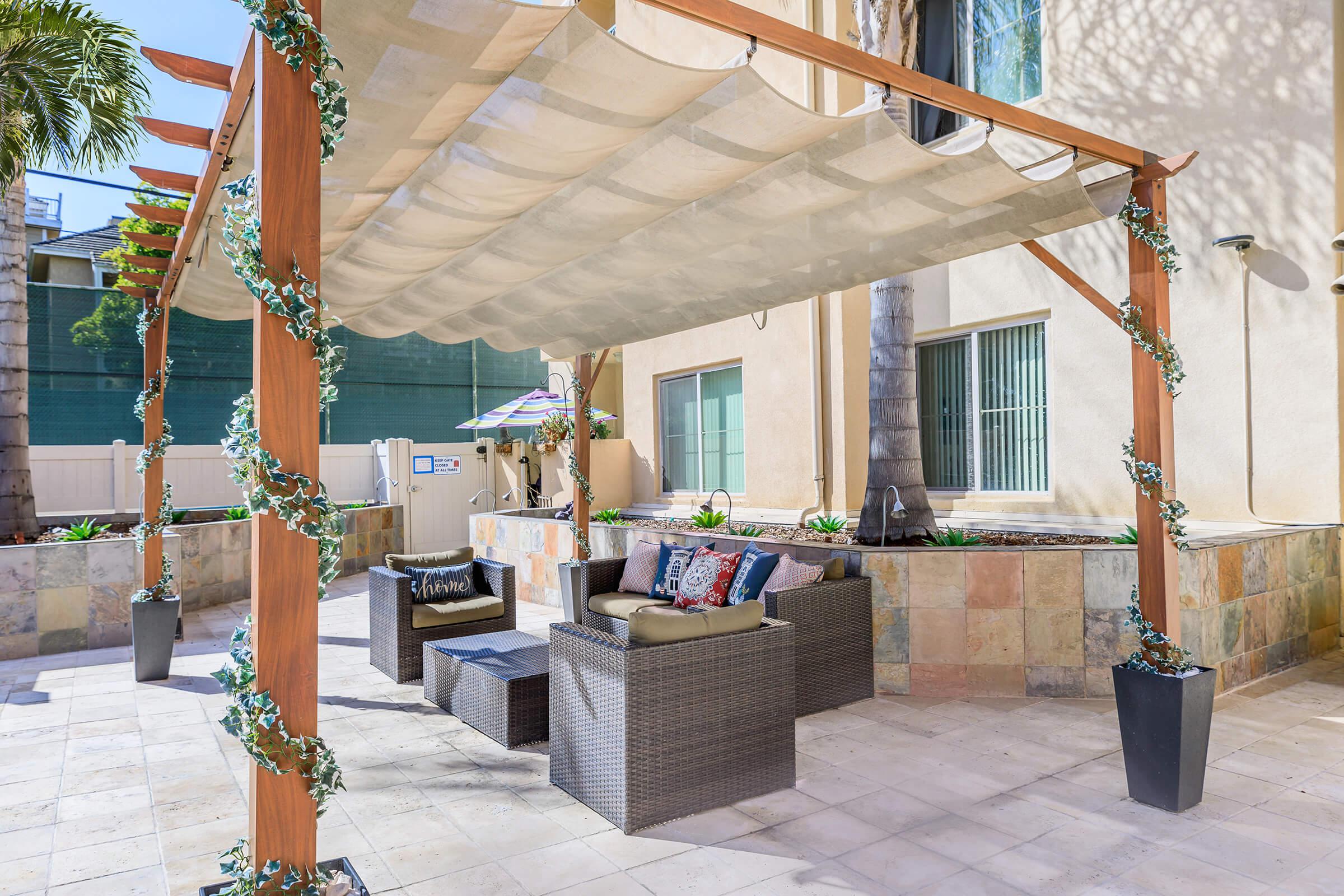 Wicker chairs under a pergola