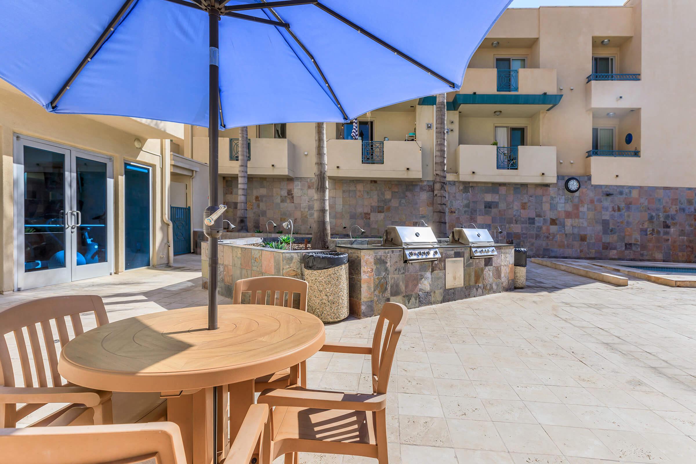 Wooden table and chairs with stainless steel barbecues