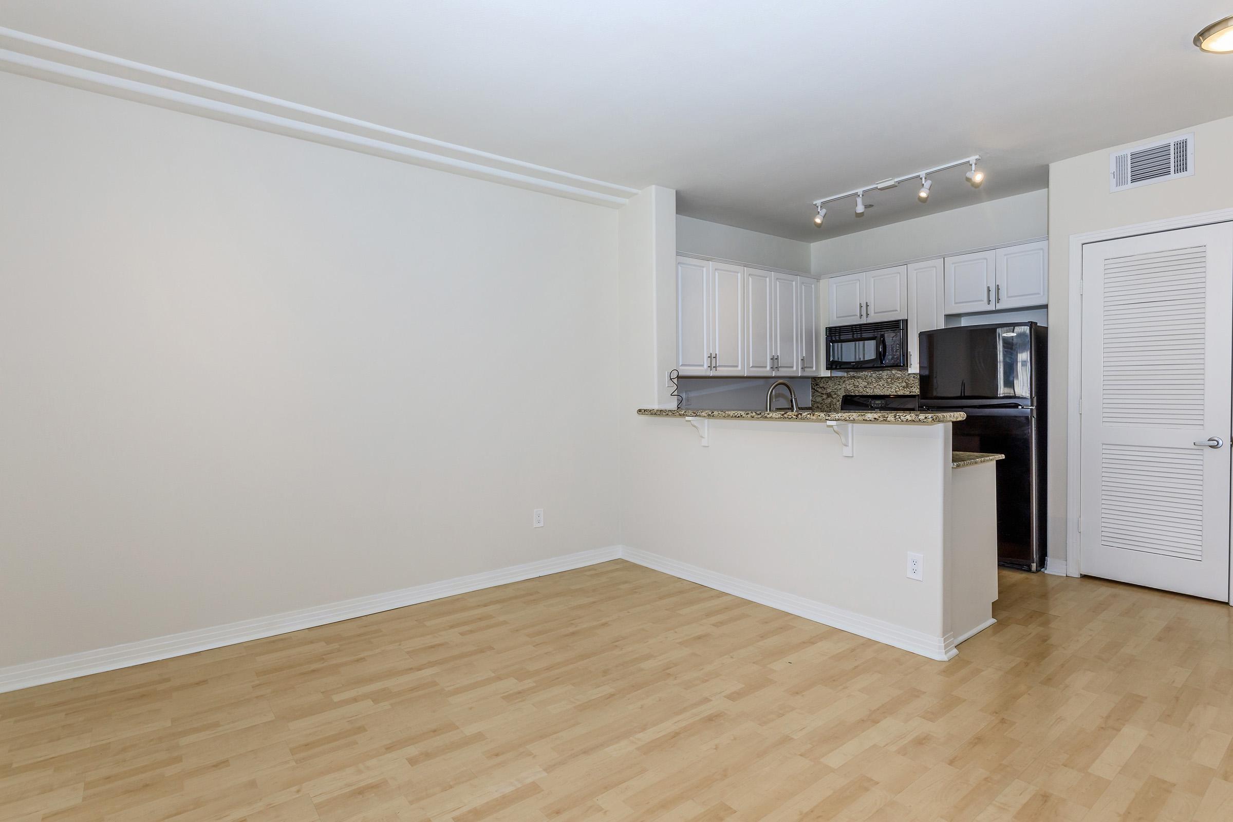 Dining room and kitchen with wooden flooring