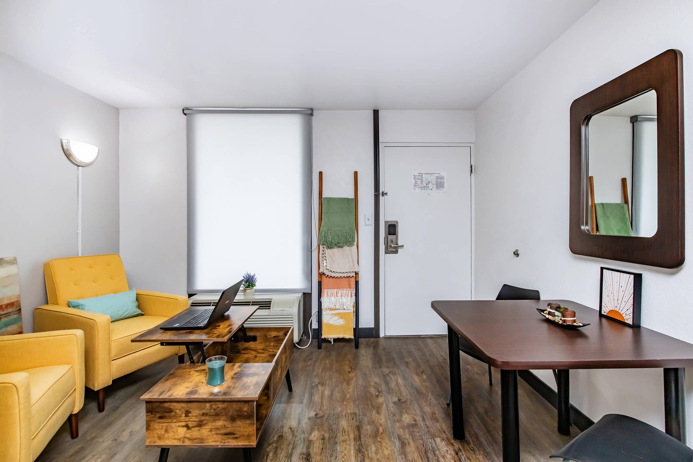 a living room filled with furniture on top of a wooden table