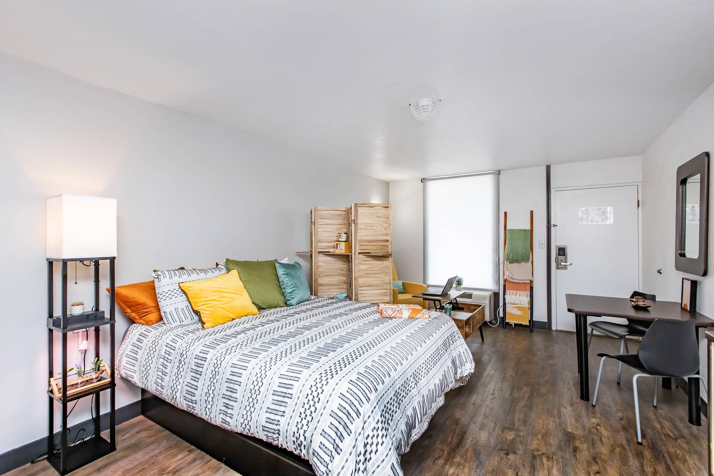 a living room filled with furniture and a bed