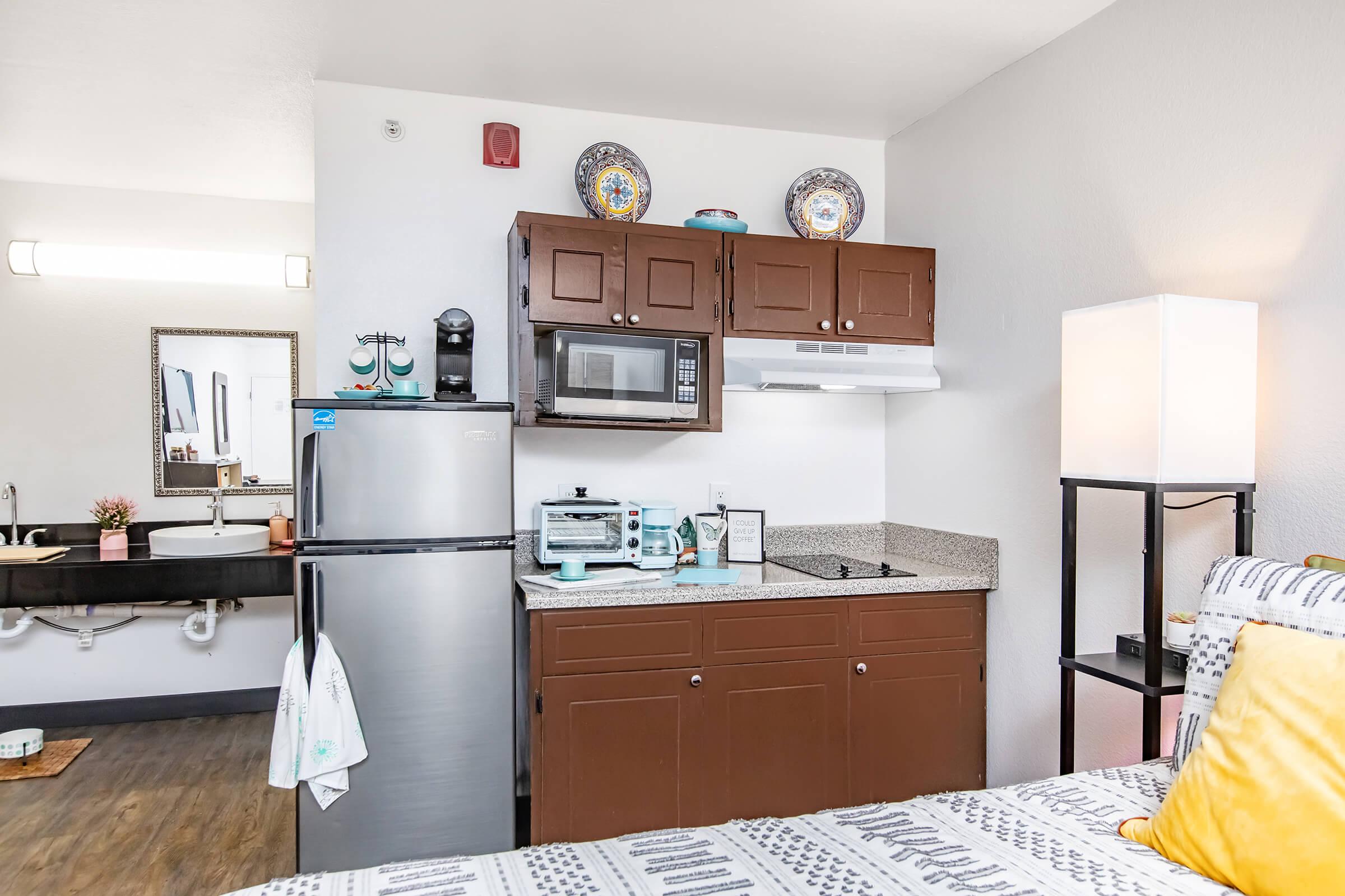 a bedroom with a bed and desk in a room