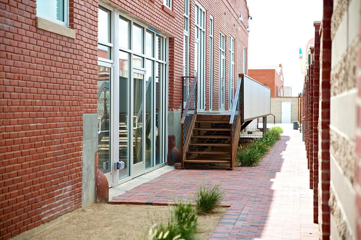 a bench in front of a brick building