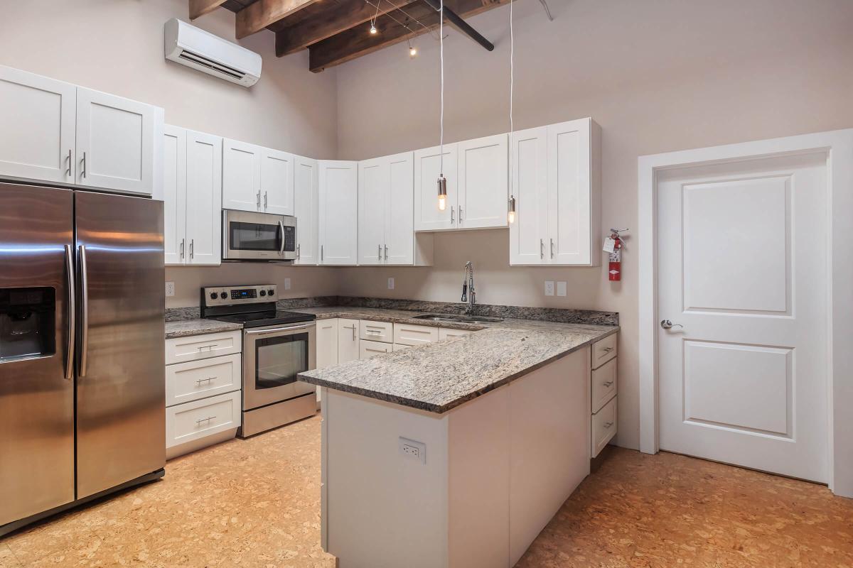 a kitchen with a stove and a refrigerator