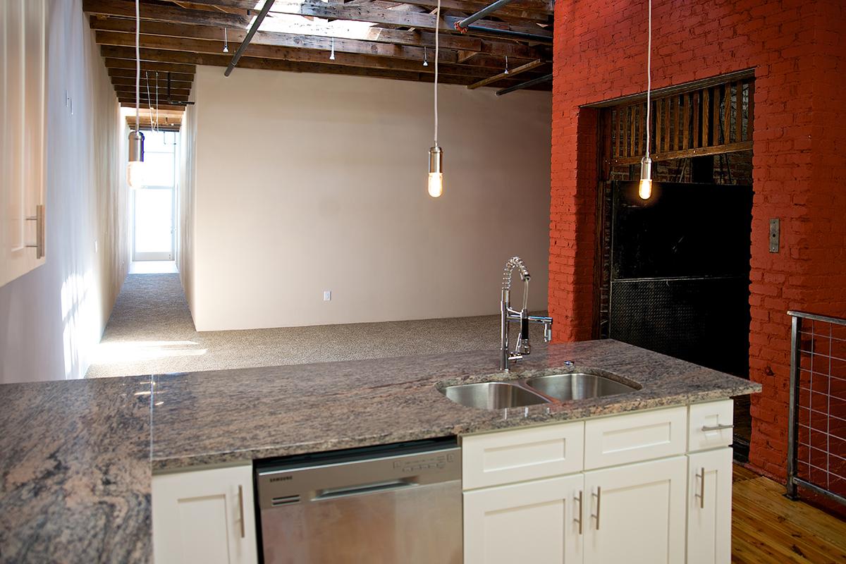 a kitchen with a sink and a mirror