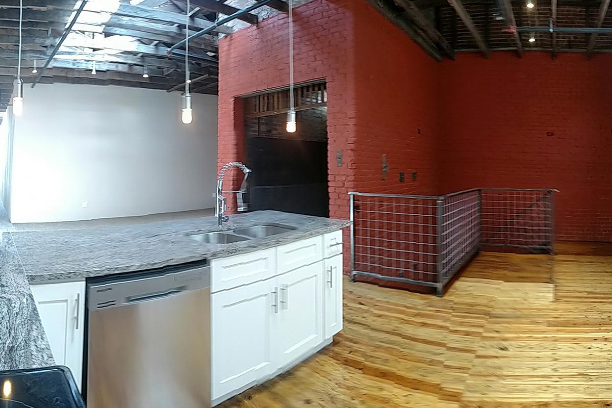 a kitchen with a stove top oven sitting inside of a building