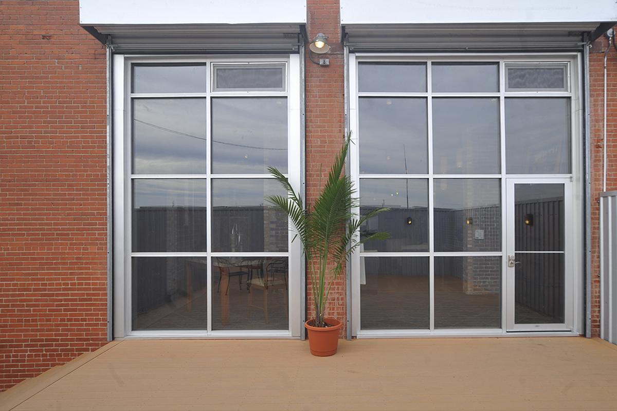 a door with a window in a brick building