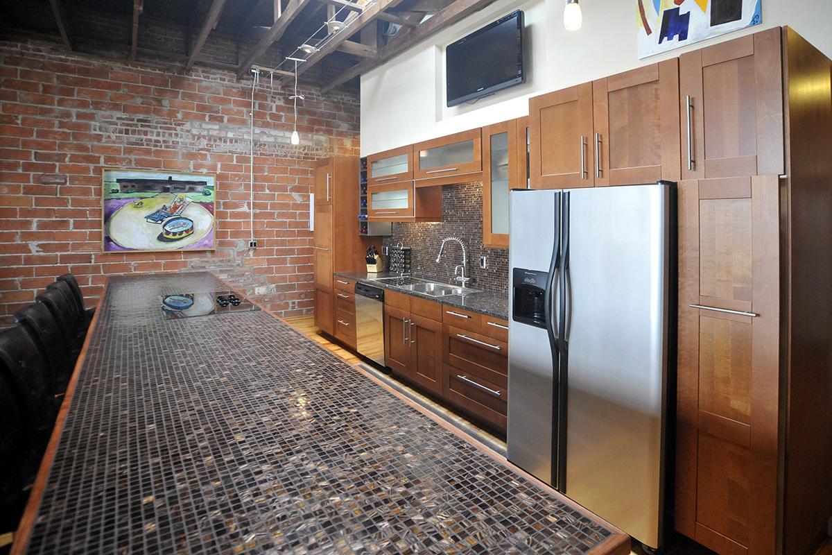 a kitchen with stainless steel appliances and wooden cabinets