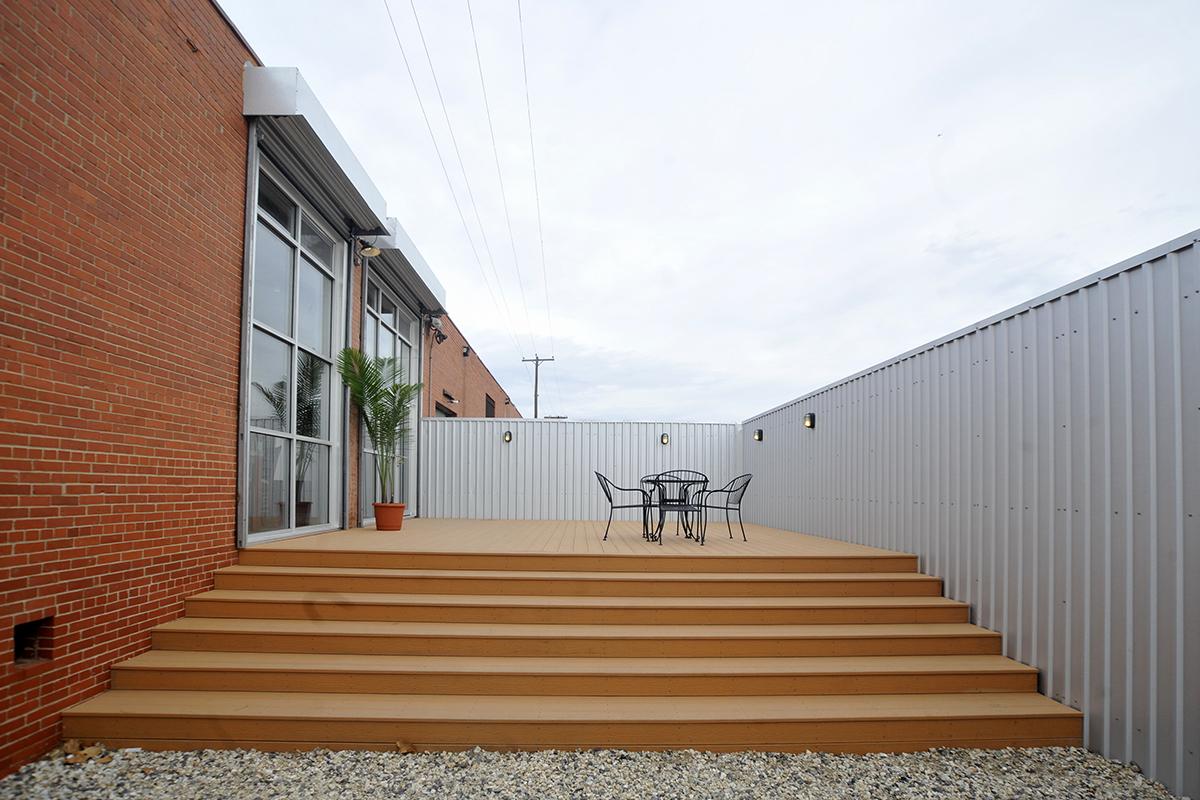 a bench in front of a brick building