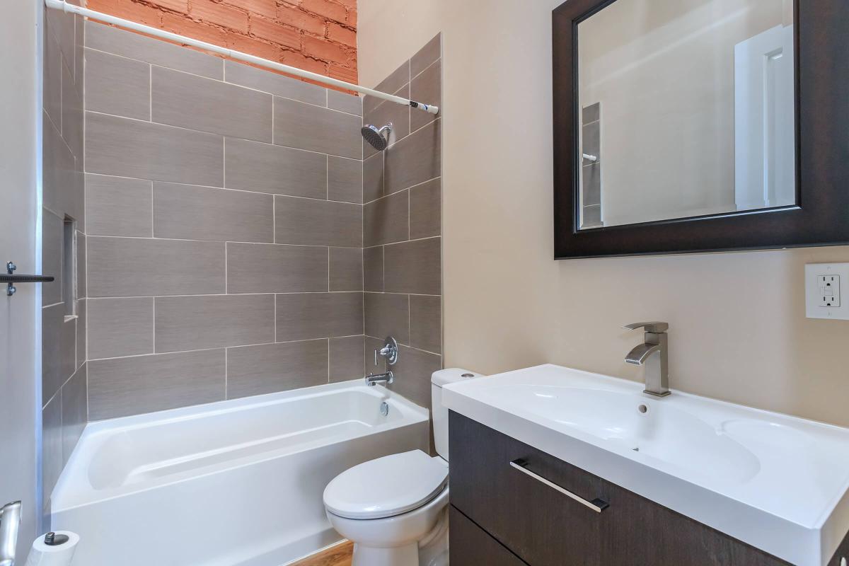 a large white tub sitting next to a sink