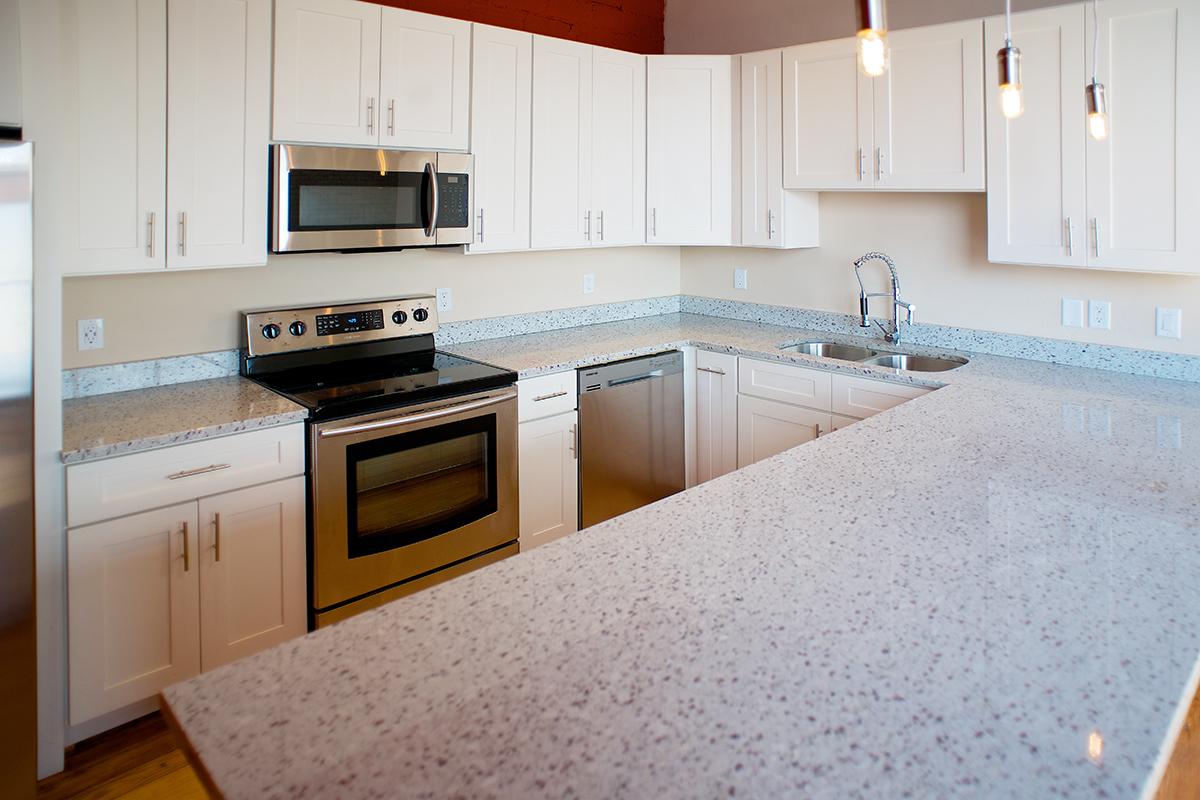 a kitchen with a stove a sink and a microwave