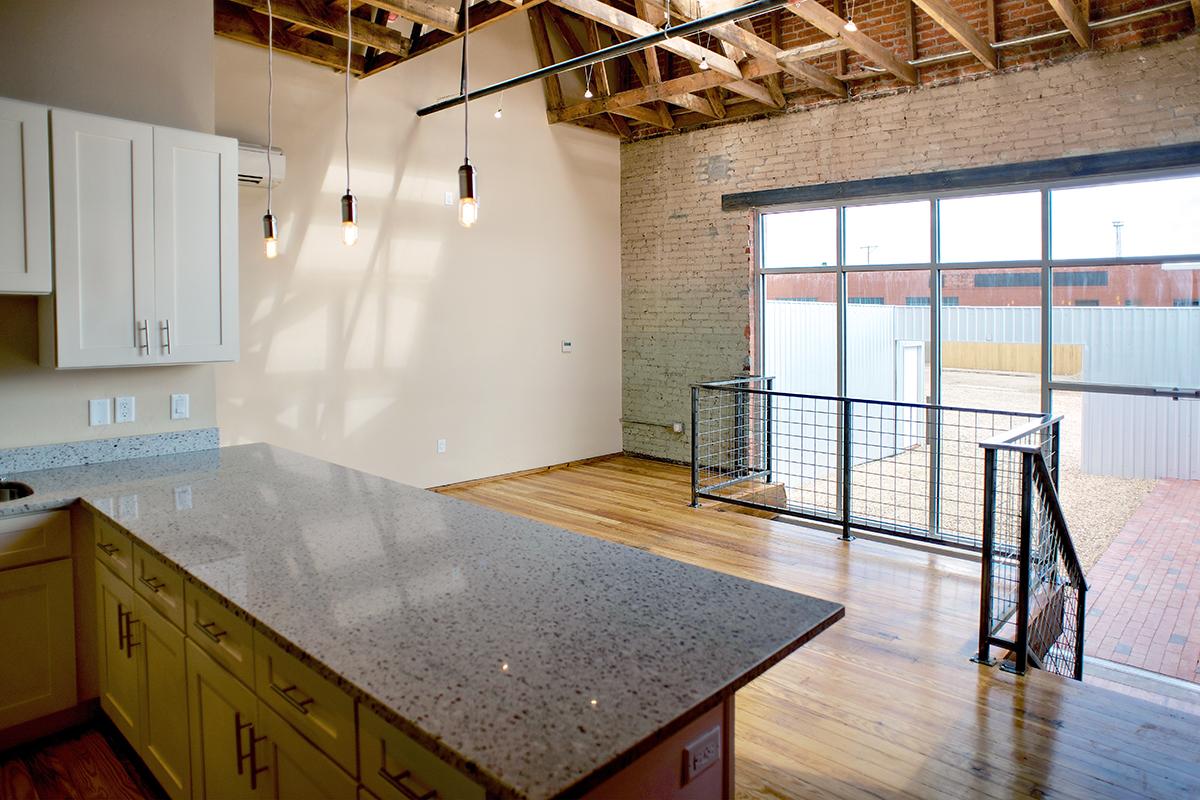 a large kitchen with stainless steel appliances and wooden cabinets